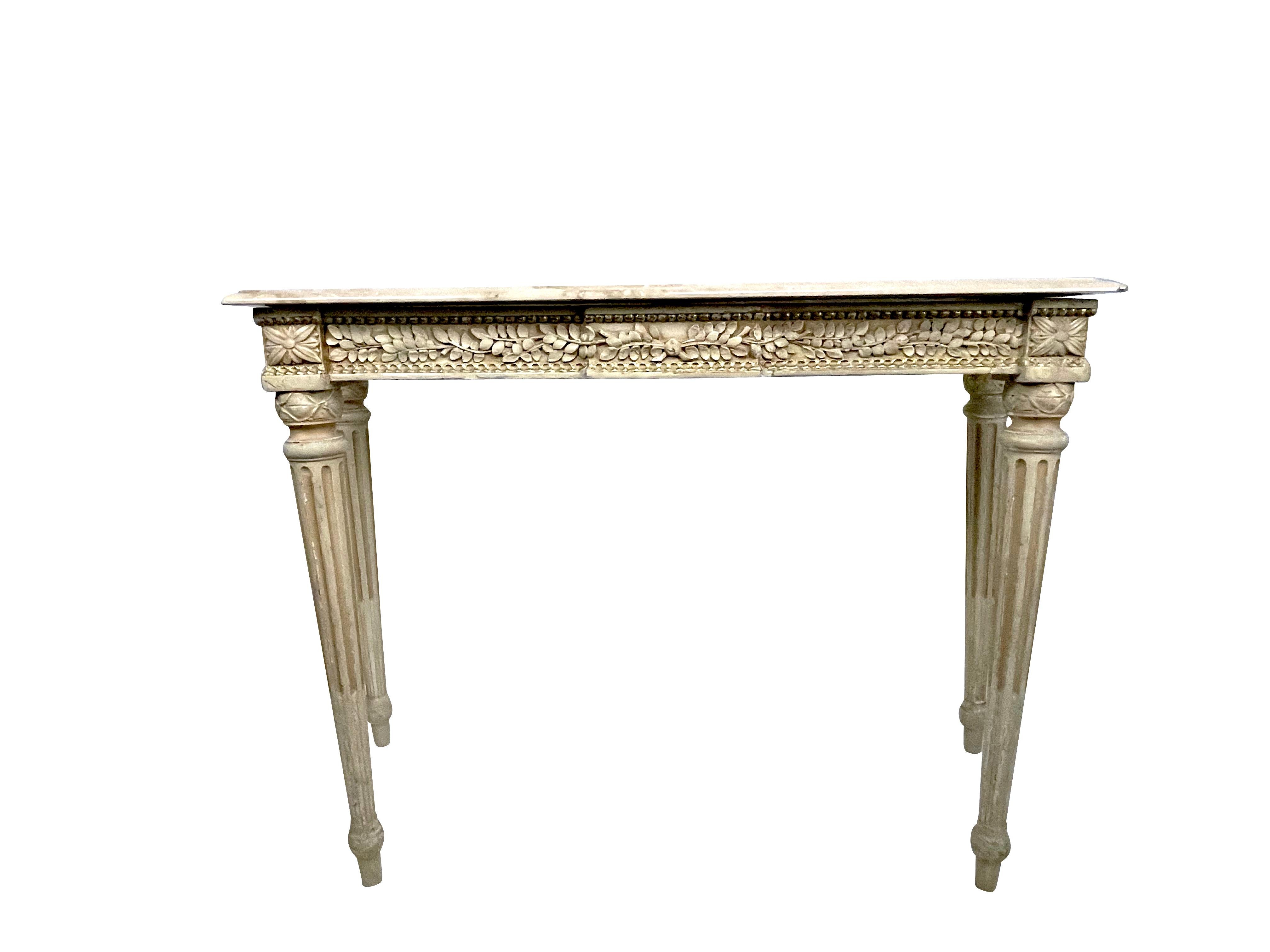 French Louis XVI Maison Jansen beige and gold gilt painted console table intricately carved with foliate detail and beaded edging. Original to the Waldorf Towers 1931 opening in New York City. Original metal label affixed to the back. Each with
