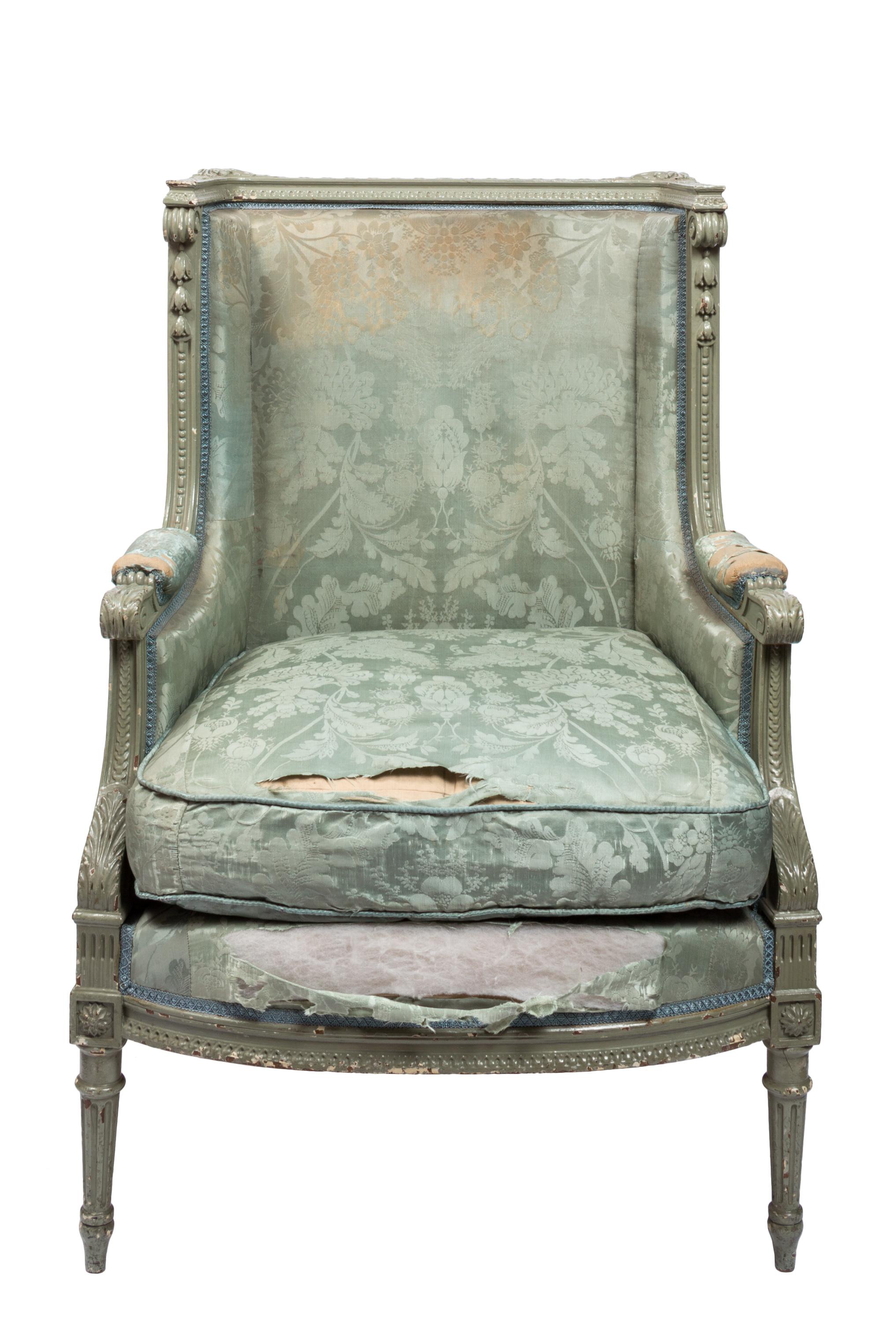 Design elements of this 19th century square-back, distressed silk upholstered armchair relate to the larger 