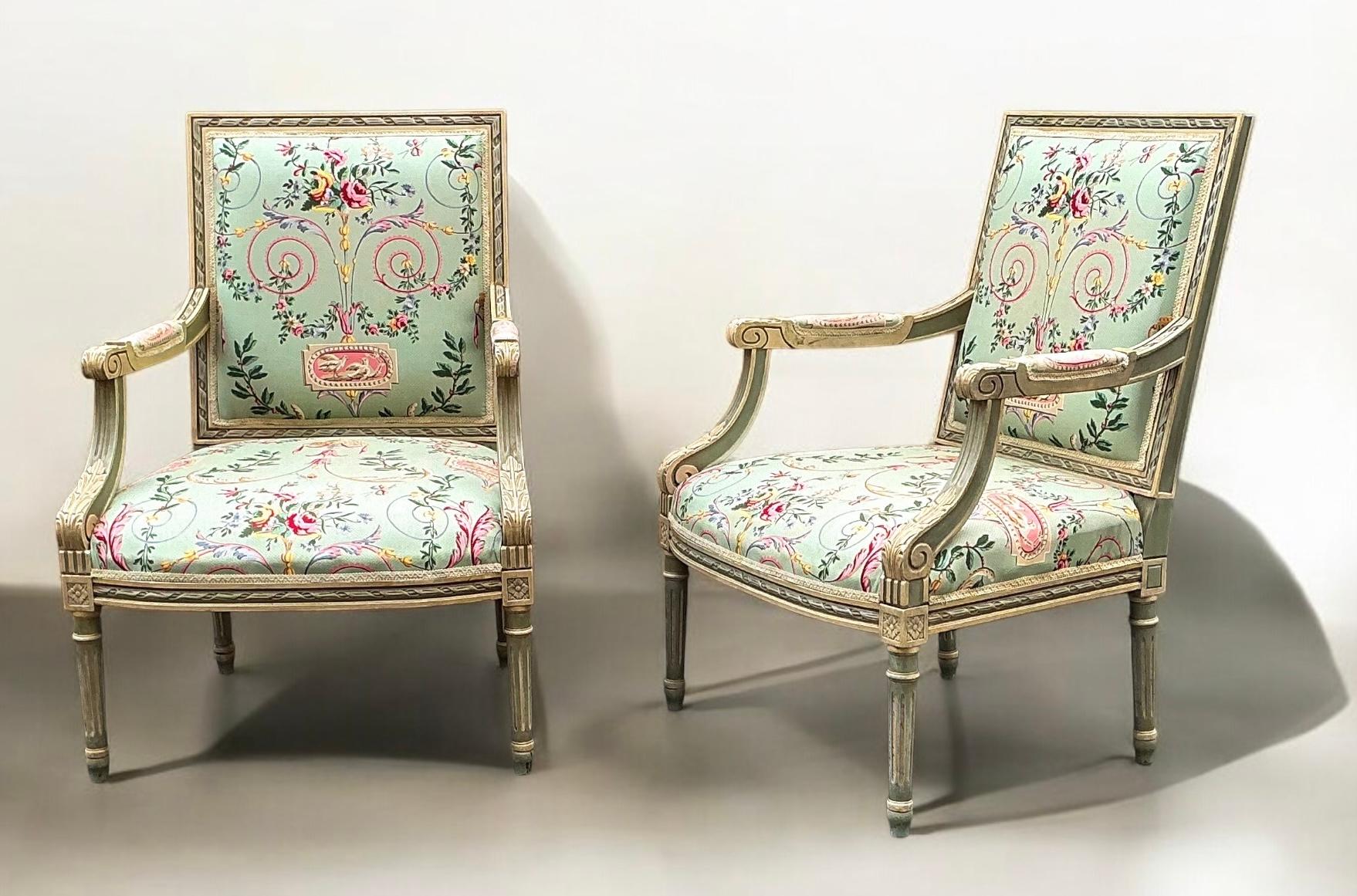 A beautiful pair of French Louis XVI carved and painted bergere chairs in a pretty neo-classical chintz. The frames are painted in and ivory and celadon. The vintage upholstery has notable wear to the arm covers, which I am happy to replace with a