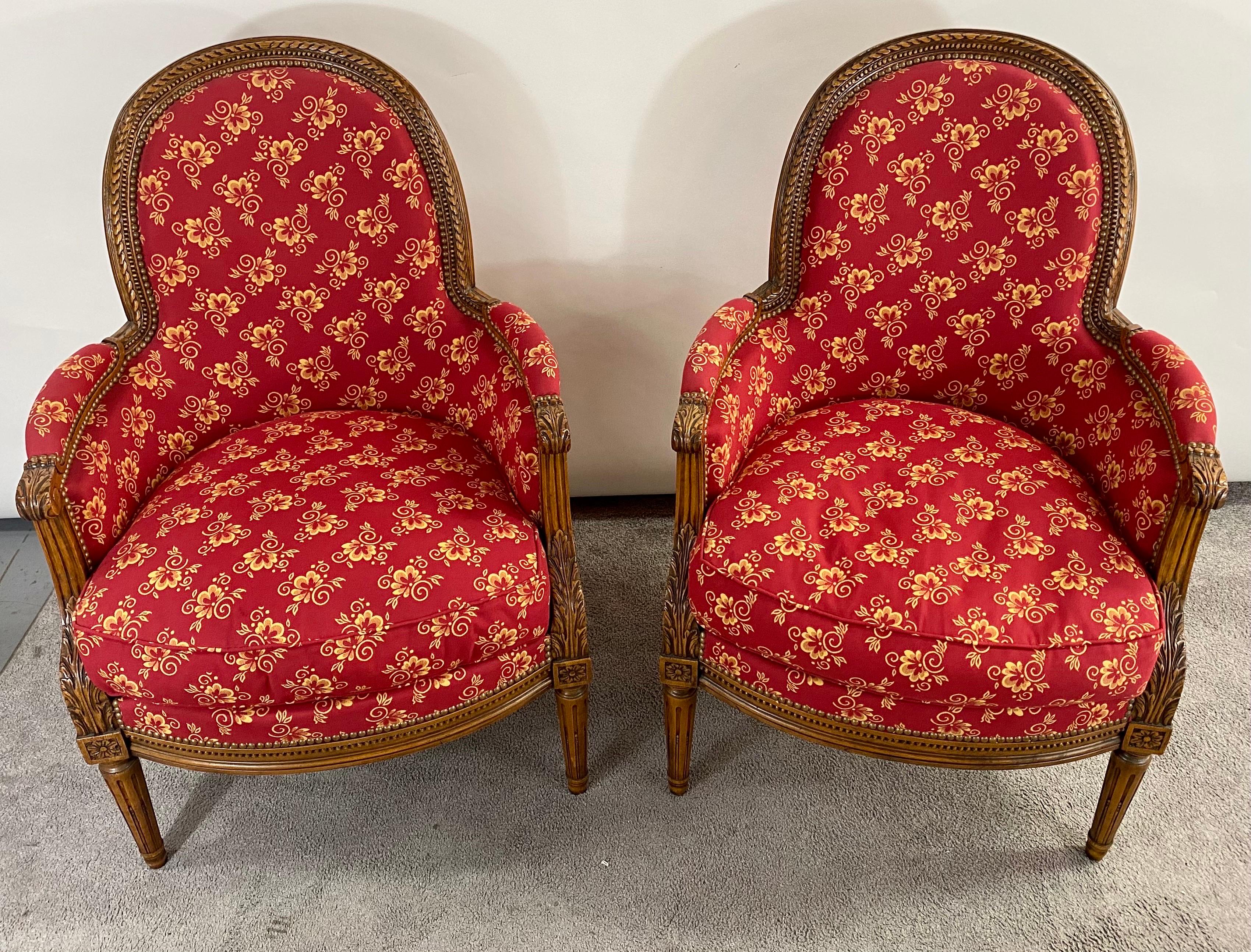An exquisite pair of French Louis XVI style bergere armchairs probably made around late 19th century, early 20 century. The frame of the chairs is hand carved of quality walnut wood showing fine carving details of acanthus and flowers. the bergere