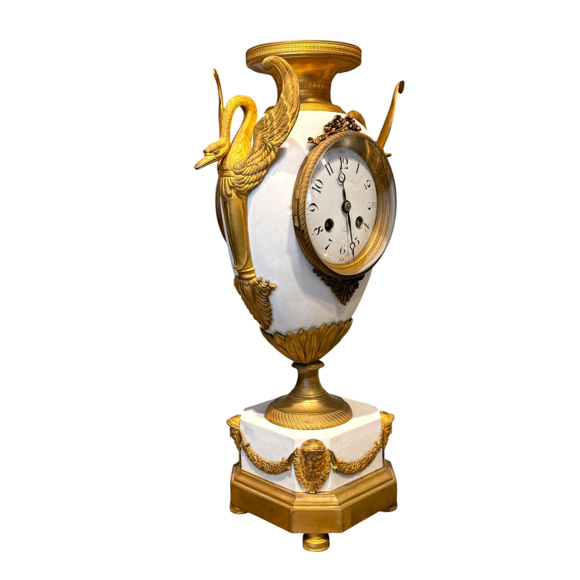 19th Century French Biscuit and Gilt Bronze Mantel Clock – “Pendule en Biscuit aux Cygnes et aux Masques d’Hercule”

A 19th-century French mantel clock, crafted in the form of a classical urn. This piece combines matte white biscuit porcelain and