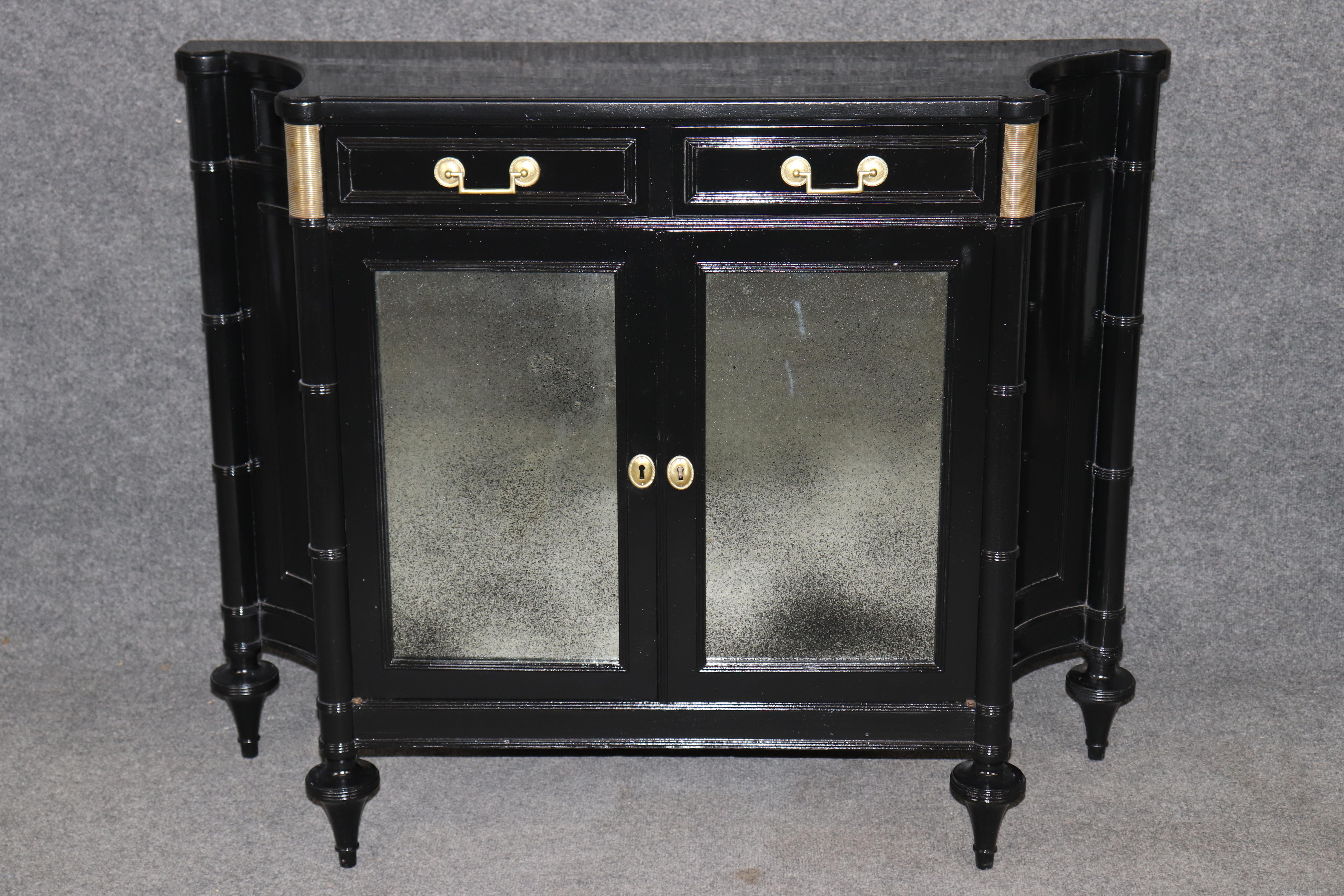 Dimensions - H: 34 in W: 43 1/4 in D: 14 1/2 in 

Elevate your interior design with this rare and refined early 20th-century French Louis XVI style black ebonized cabinet or server, beautifully retailed by the prestigious Angelo Romano Ltd. A
