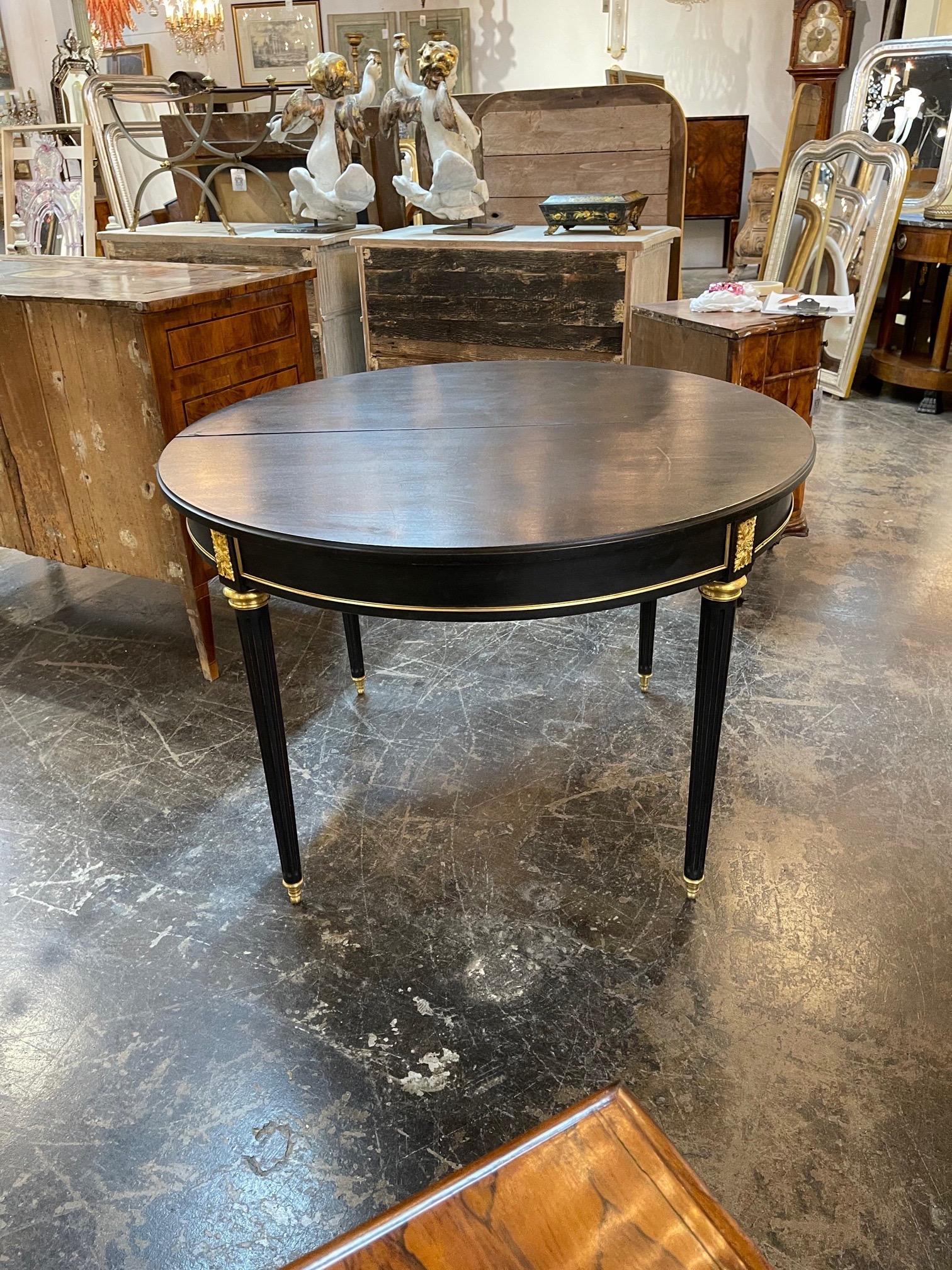 Gorgeous French Louis XVI style black lacquered and brass breakfast table. A lovely additional for an elegant home!
