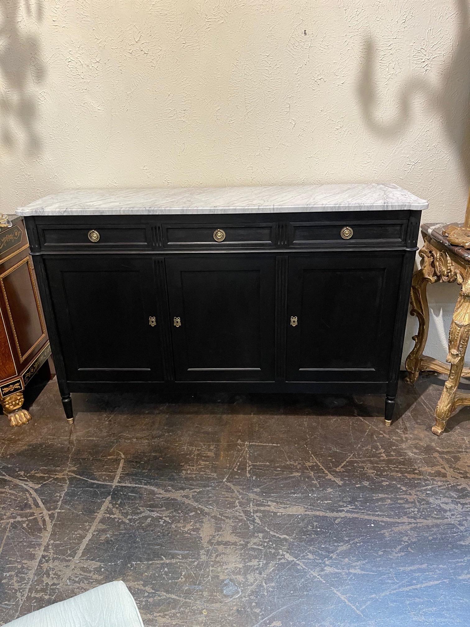 Elegant French Louis XVI style black lacquered buffet with marble top. This piece is very fine quality and has ample storage as well! Creates a Classic look.