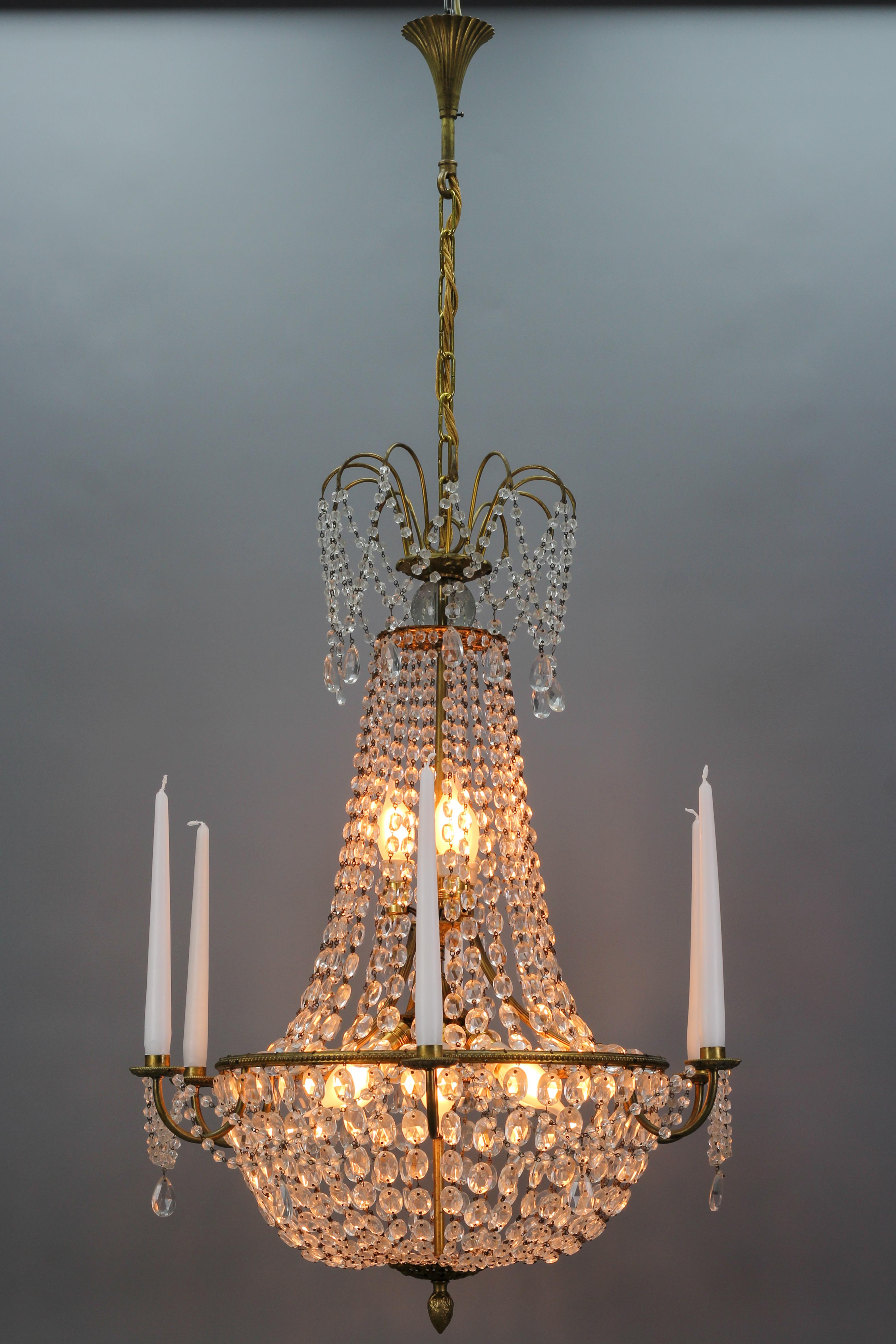 Beautiful, subtle late 19th century Louis XVI style brass and crystal basket chandelier with a fountain corona, having an elegantly draped canopy with cascading bead crystals and almond-shaped prisms. This superb French chandelier features six