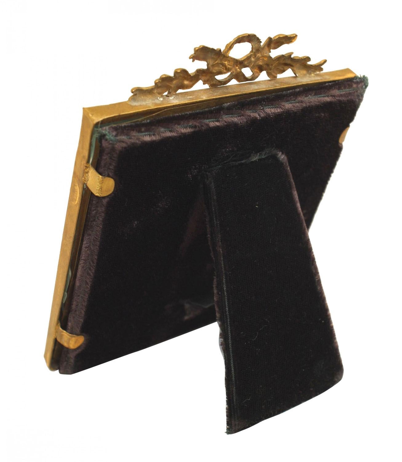 French Louis XVI-style square shape brass easel picture frame with rope design border and wreath motif pediment top.