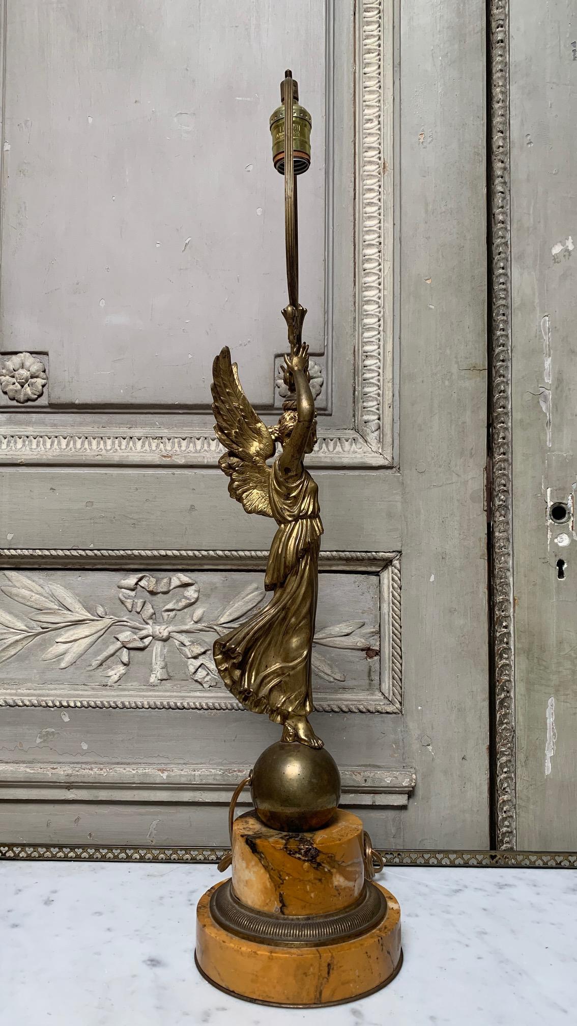 French marble and bronze lamp base depicting winged victory in the Louis XVI style. 
This lamp can be wired at an additional cost.
 