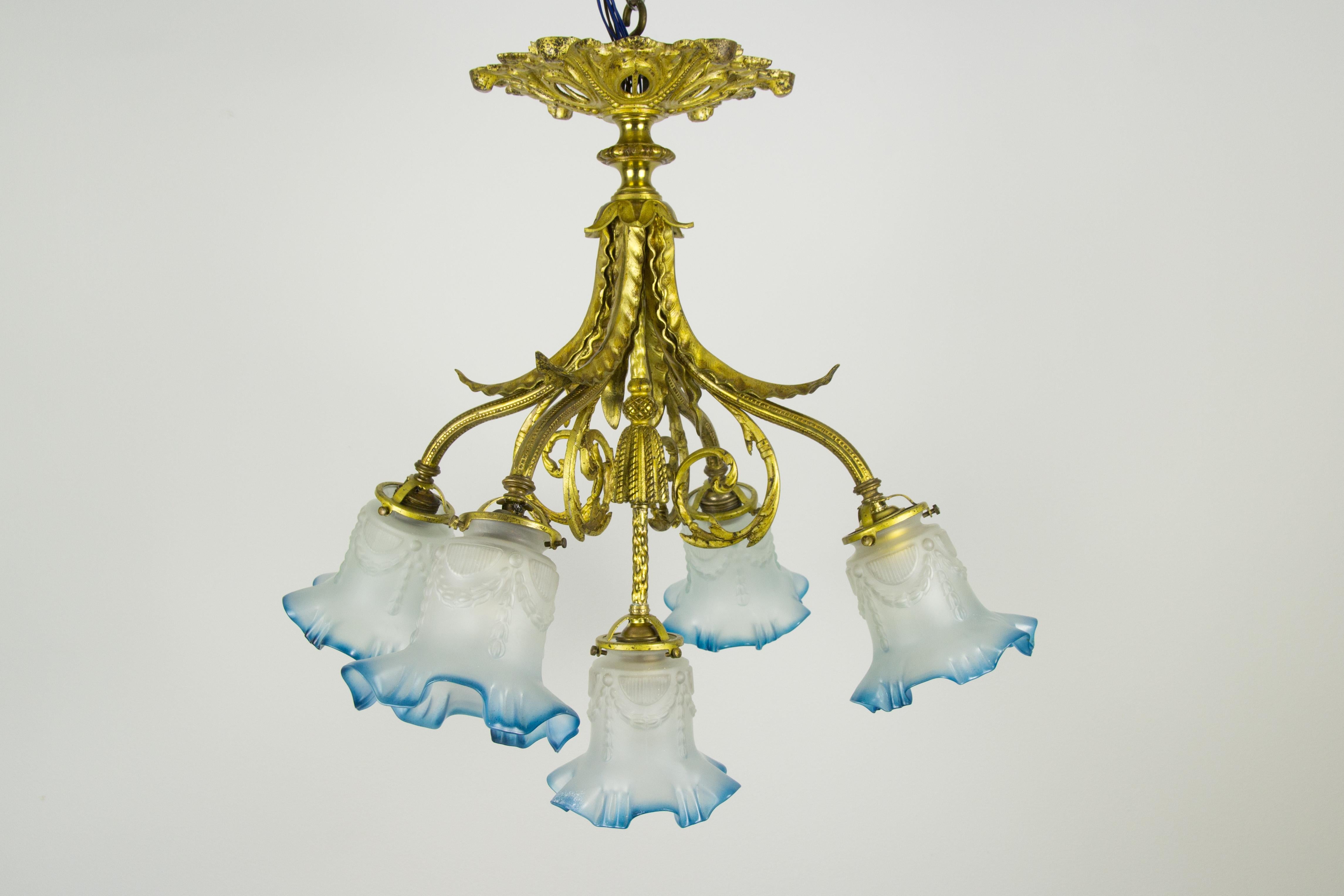 Beautiful Louis XVI style bronze chandelier from the 1920s, five bronze arms with very decorative frosted glass shades. The chandelier has five sockets for E27 (E26) size light bulbs.
Measures: Height is 20.66 inches / 52.5 cm, diameter – 22.04