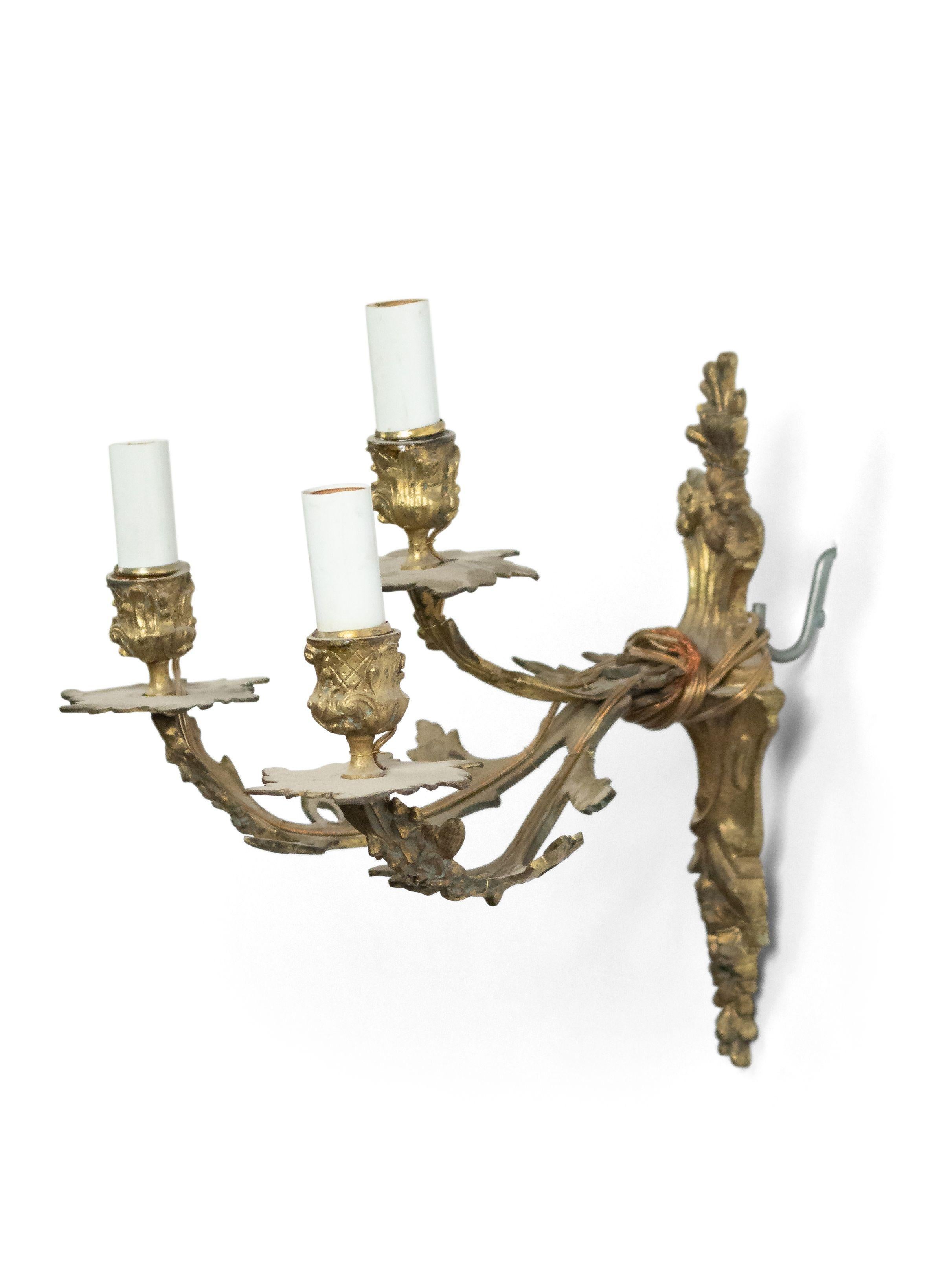 Pair of French Louis XVI style 19th-20th century bronze dore 2-tier 3-arm wall sconces with floral design.