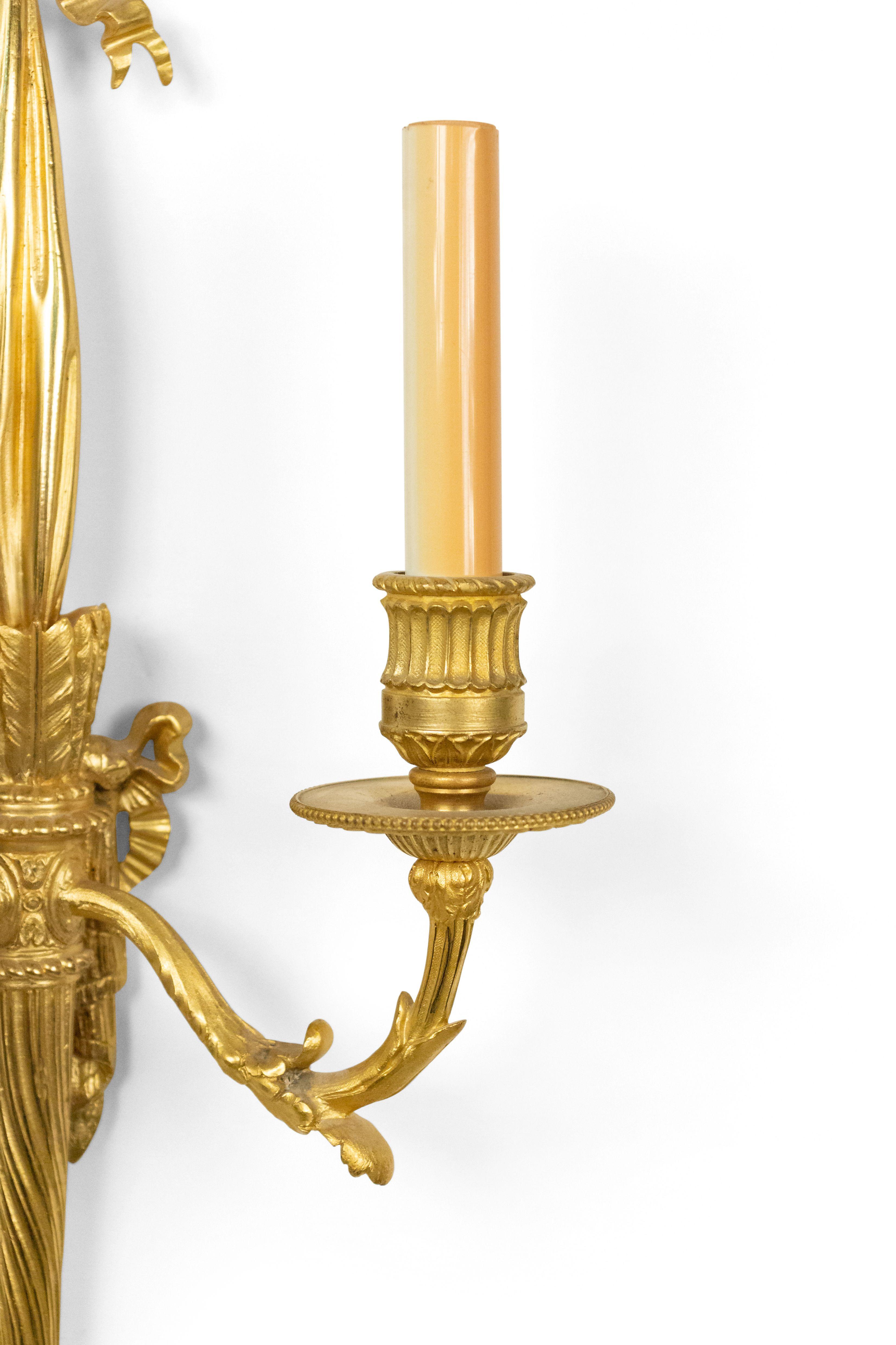 Pair of French Louis XVI style (19th century) bronze doré 2 scroll arm wall sconces with torch and drape design and bow knot top and fluted bobeche.
