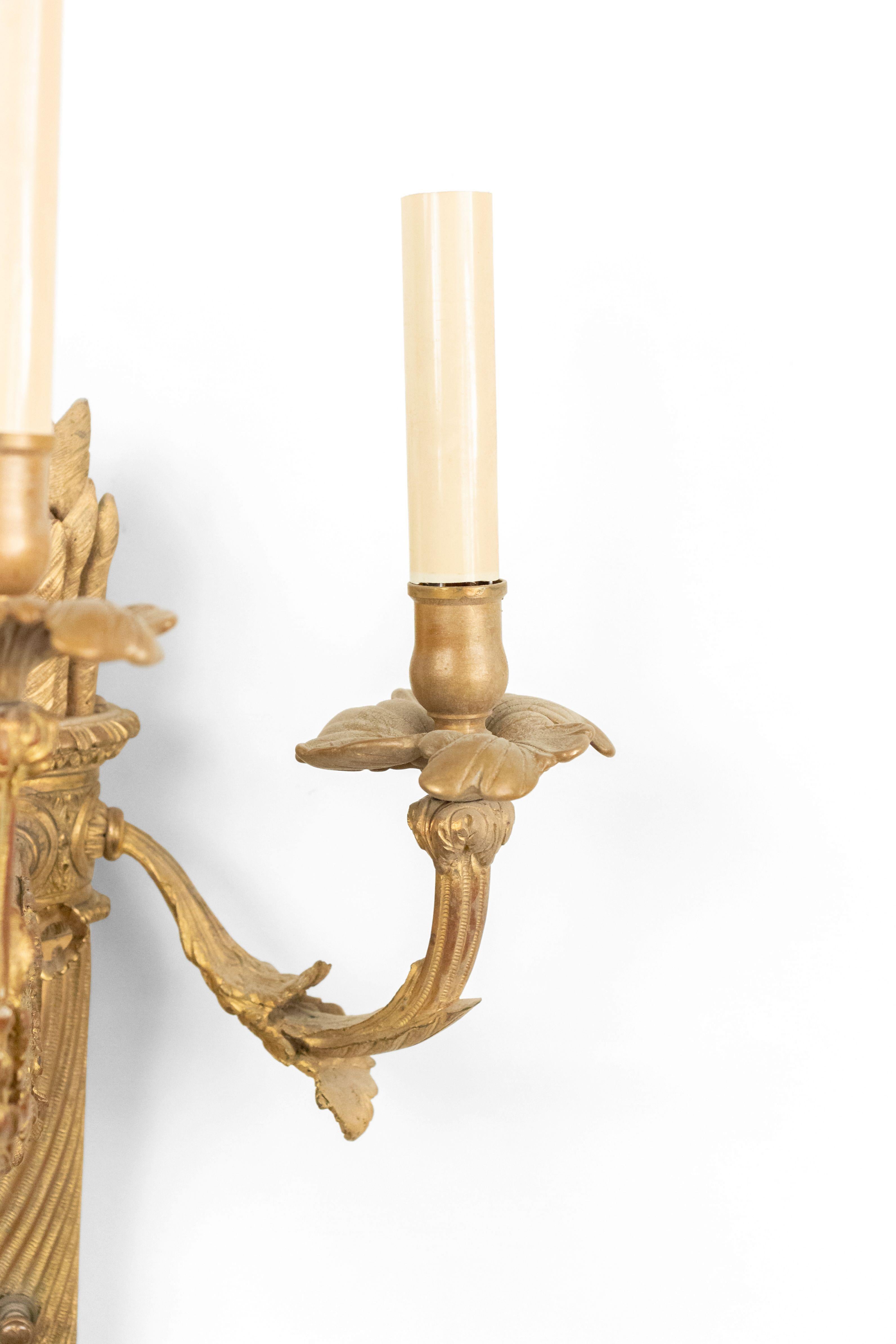 Pair of French Louis XVI style bronze dore 3 arm wall sconces with torch design and arrow top (19th Century).