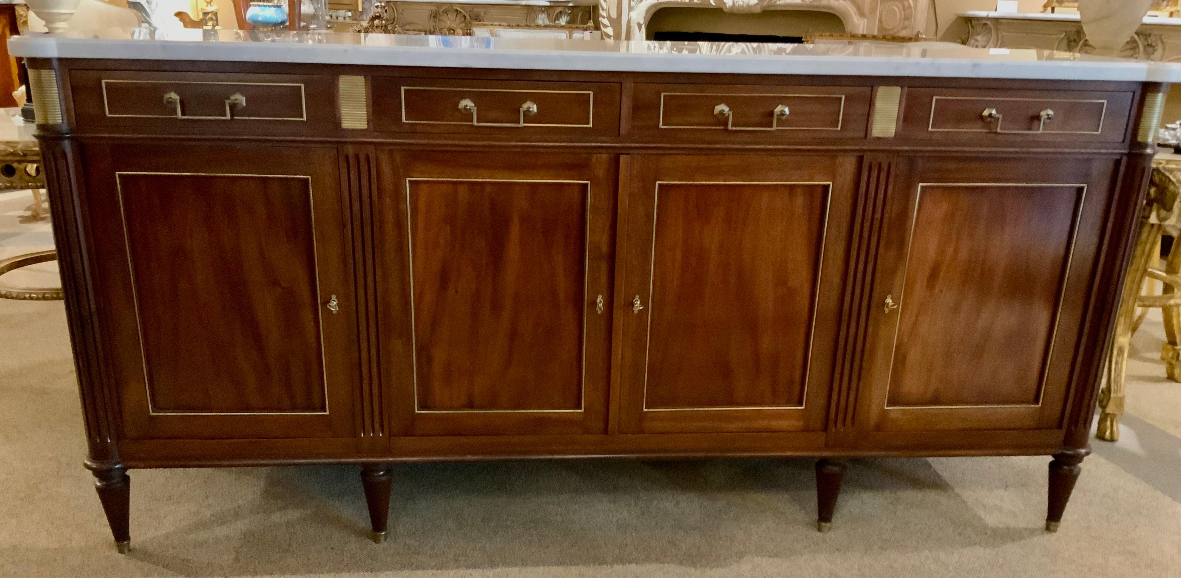 The mahogany in this piece is a rich deep color and the quality
of the cabinet is very apparent in the expert craftsmanship 
that has been expertly used throughout the process.
It has four doors that open easily for storage and each open
to one
