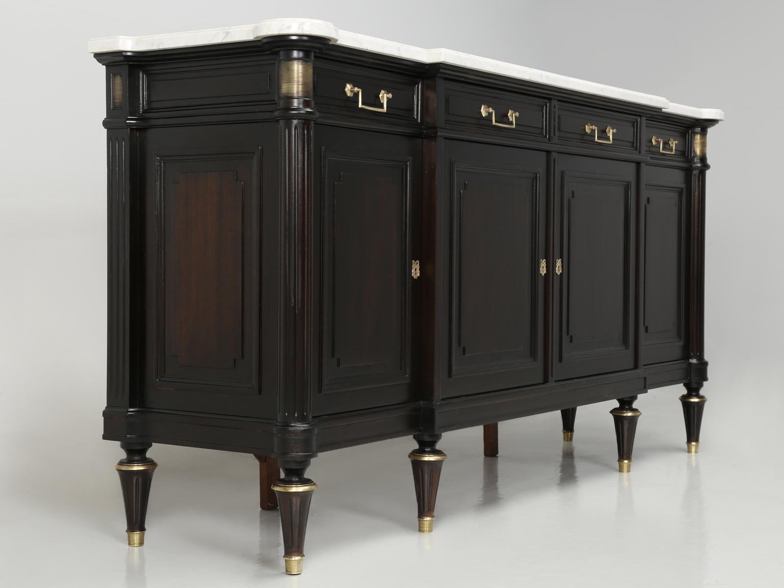 French Louis XVI style buffet that has just come out of our old plank restoration department and we made the decision not to ebonize this French Louis XVI style buffet, but rather apply a coffee bean stain. From a distance, this French buffet does
