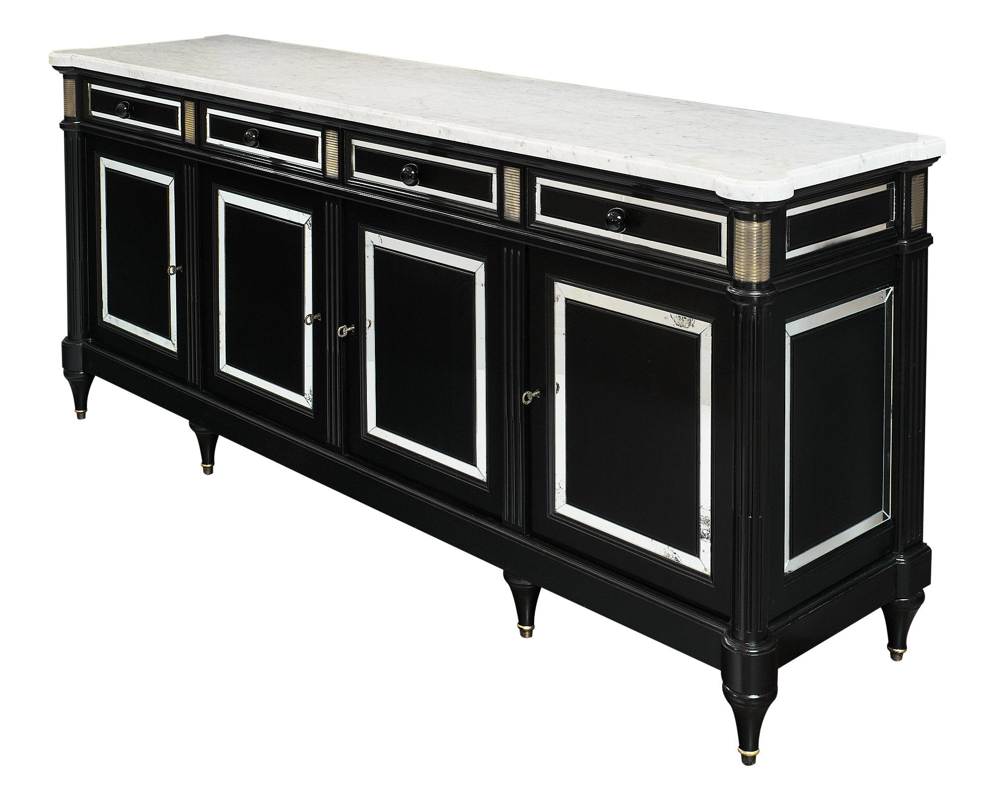 Louis XVI style French buffet made of ebonized mahogany finished with a lustrous French polish. This piece is topped with an intact Carrara marble slab and features brass trim details. Four dovetailed drawers have Murano glass knobs, and the four