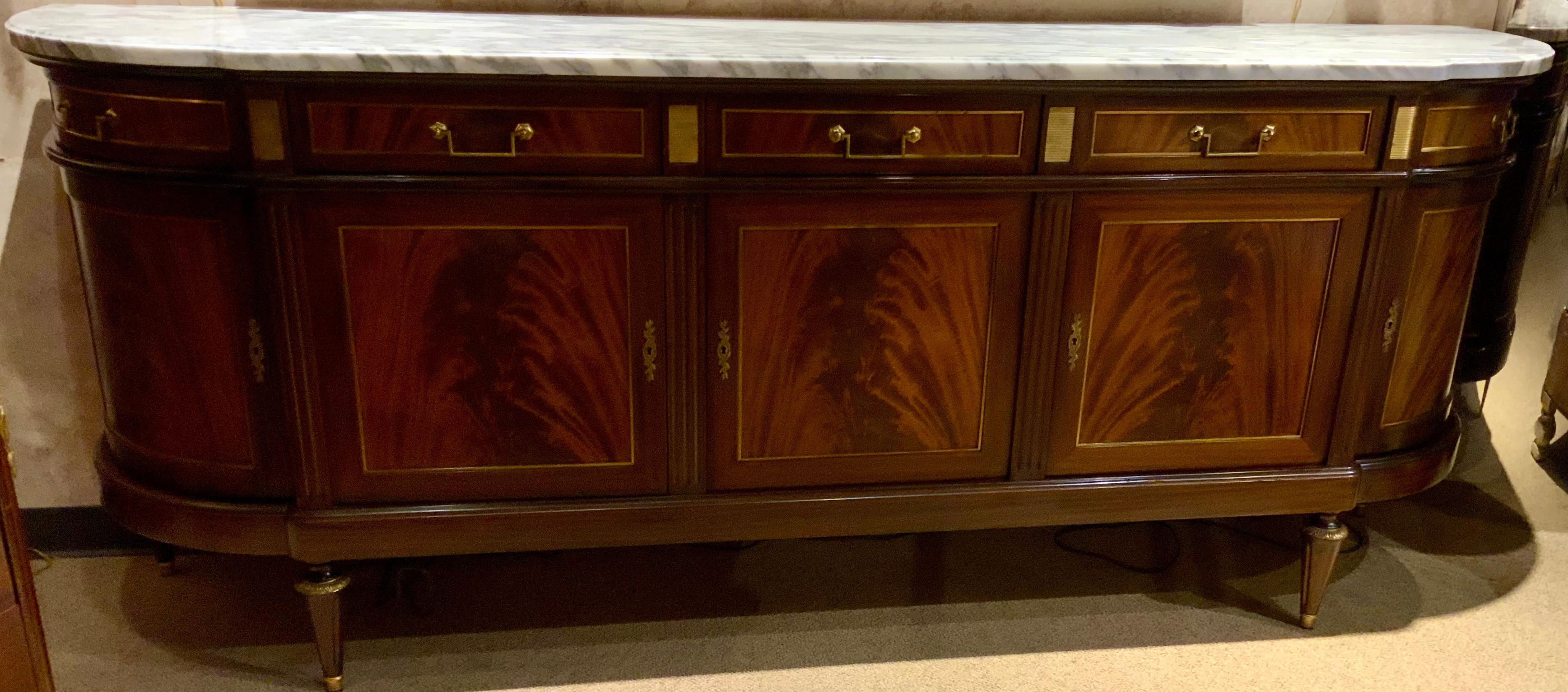 The quality in this piece is superb, made of the finest crotch mahogany 
With exceptional construction. The white marble Top is without any
Problems or stains. It has a light pale Gray vein running throughout.
It has five doors that open freely to