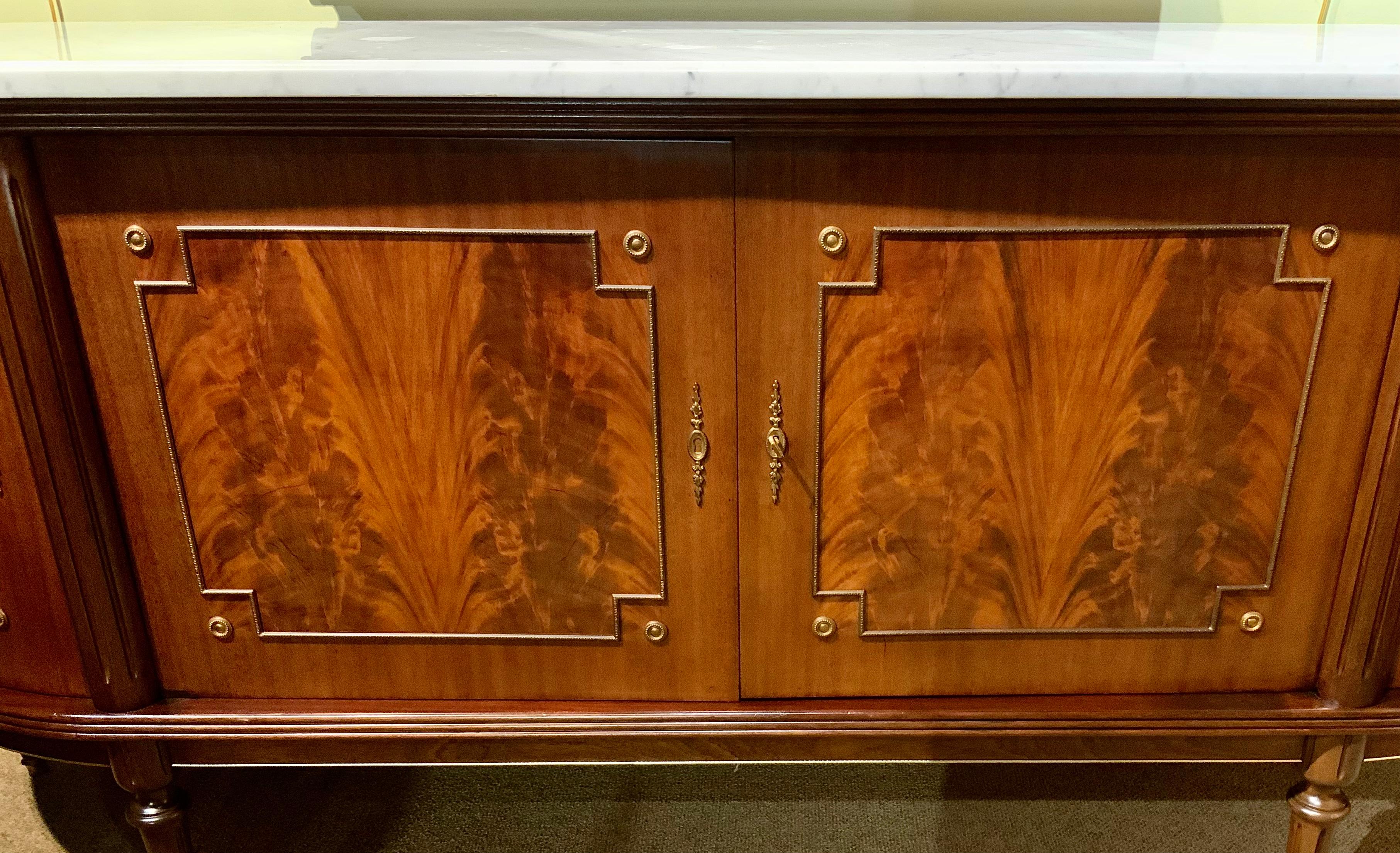 The flame mahogany wood in this piece is of the finest quality and
The cabinetry is exceptional. The sides are gracefully curved and all
Doors open and close with ease and without problems. There are two
Shelves within the central cabinet and one