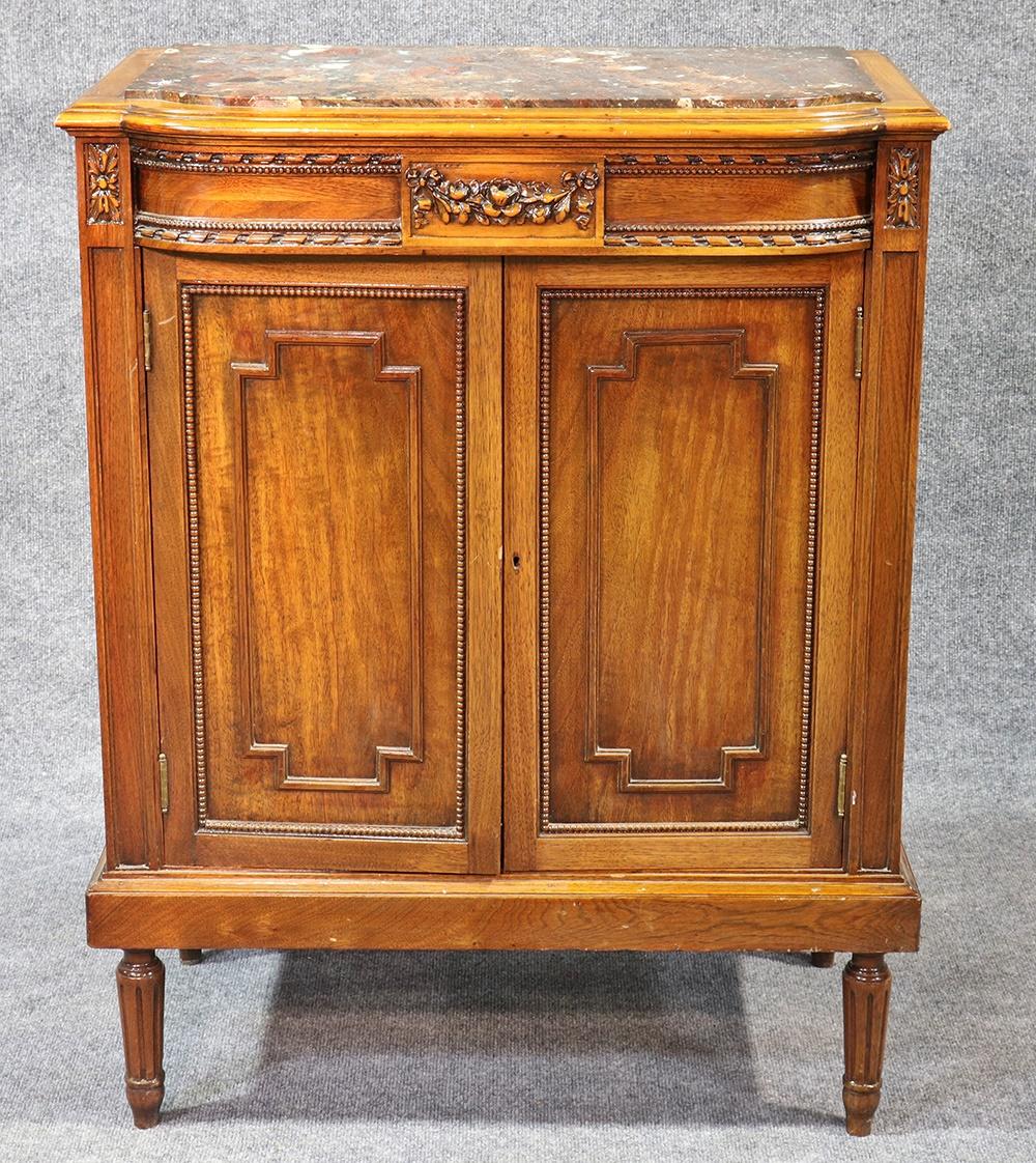 This is a gorgeous multi-use cabinet. It can be a nightstand or shoe cabinet or anything else you want it to be. The cabinet is carved walnut with a unique undamaged marble top. The overall design and size make this a pleasing and easy to use 1920s