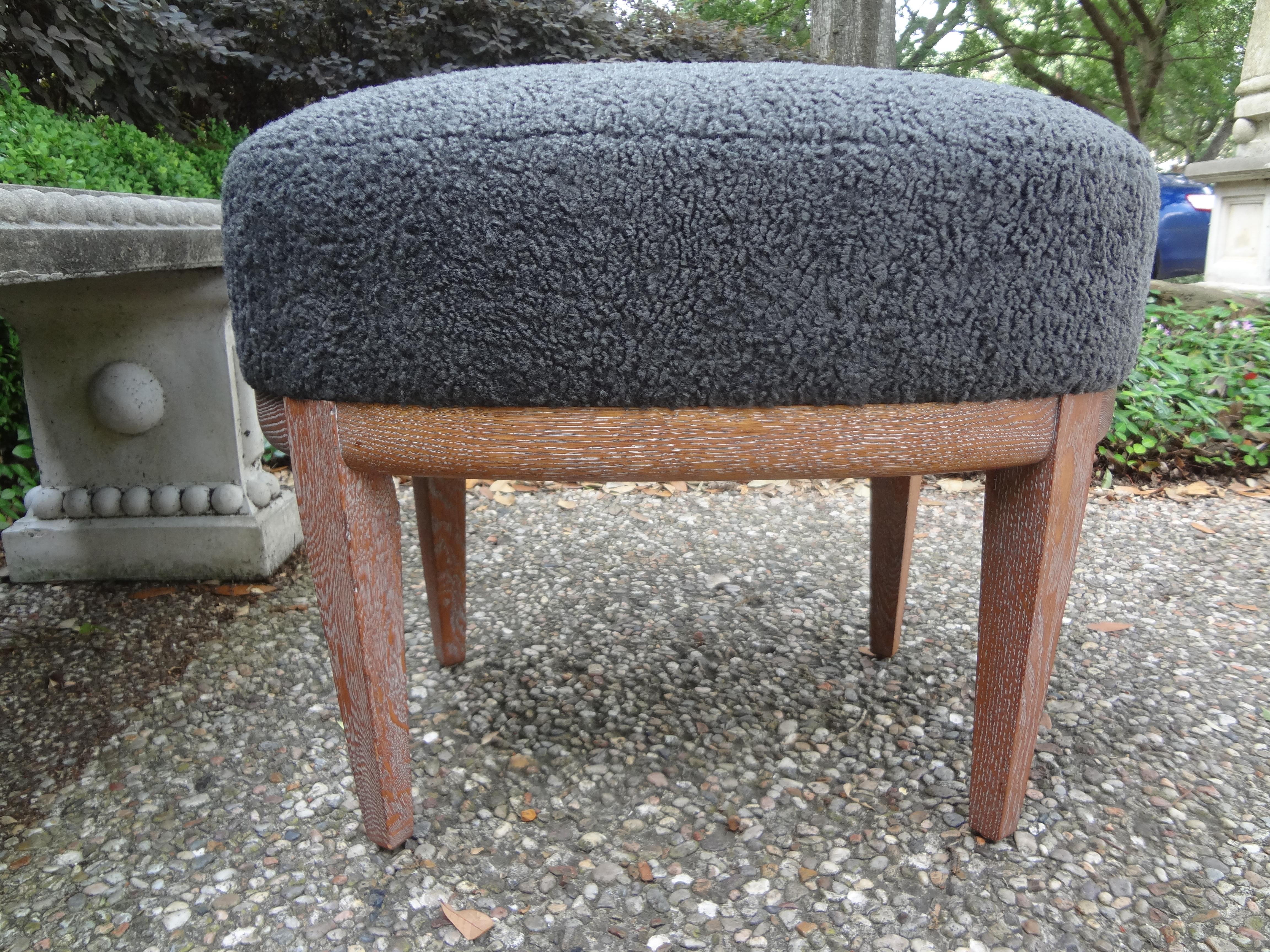 French Louis XVI style cerused oak bench or ottoman.
Handsome French 1940s cerused oak oval bench, ottoman or stool. This stylish French Louis XVI style limed oak ottoman has been newly upholstered in plush faux gray shearling. Our versatile and