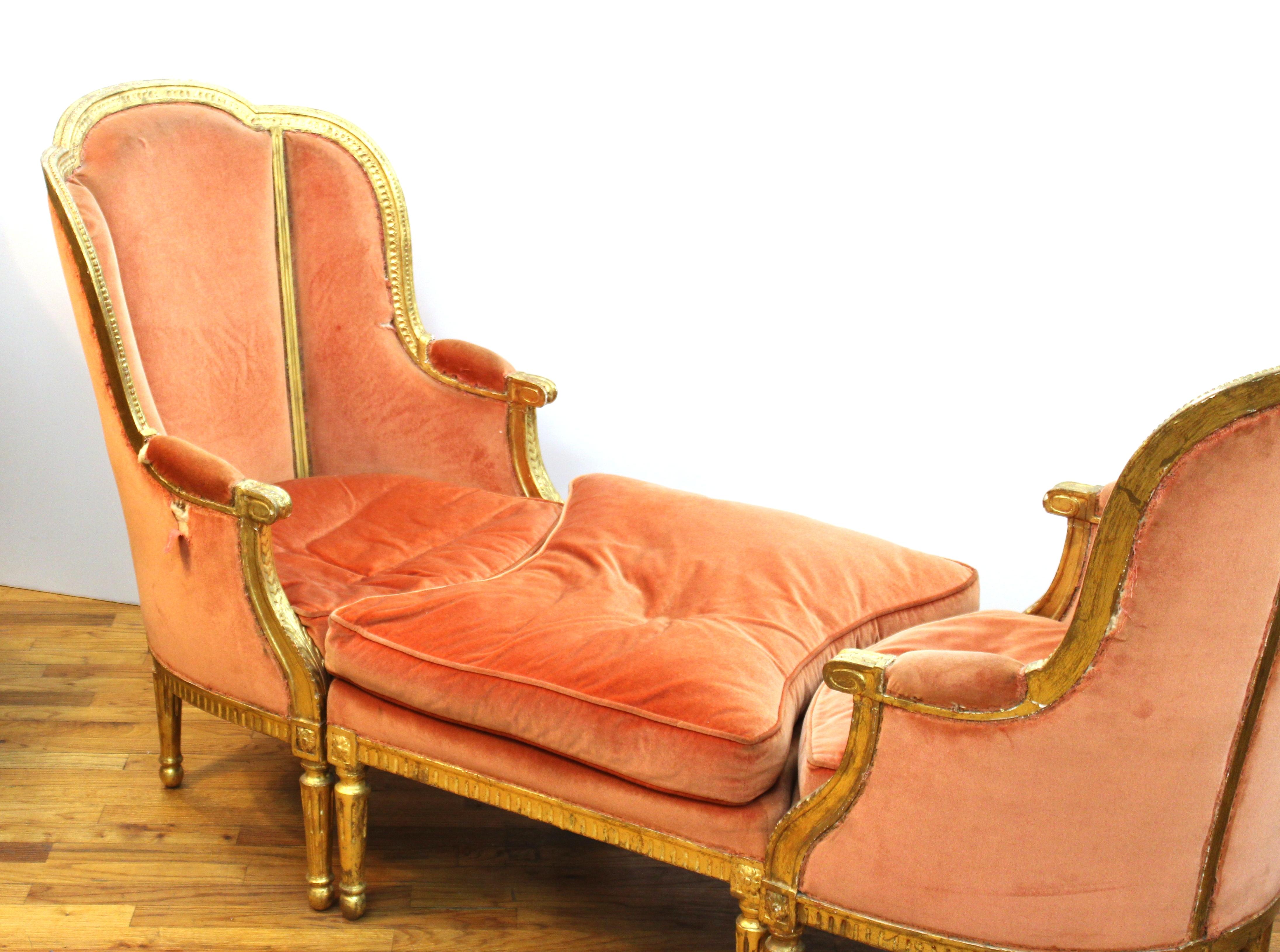 French Louis XVI style set of two giltwood fauteuils and one ottoman, forming a chaise lounge when assembled. In great antique condition with age-appropriate wear and some tears to the fabric.
