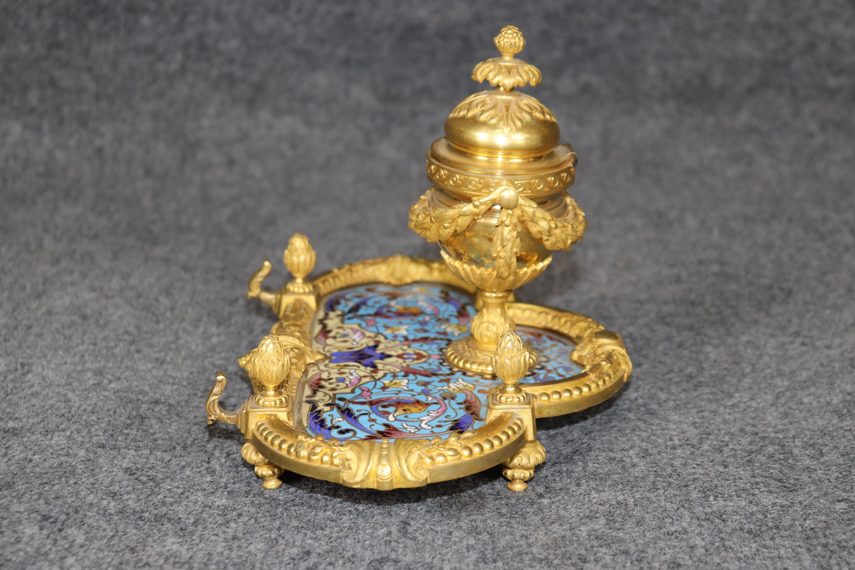Dimensions - H: 7 1/2in W: 10 1/2in D: 7 3/4in 

This Late 19th Century French Louis XVI Style Champlevé and bronze Ormolu Inkwell is truly a sight to be seen! If we take a look at the photos provided we can see the incredibly crisp and detailed