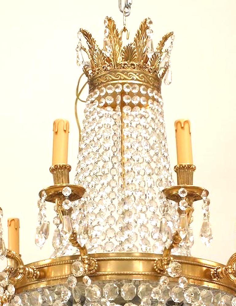 French Louis XVI-Style chandelier with 12 arms supported by a bronze ring with multiple beaded crystal strands converging on a bottom finial and extending to top.
