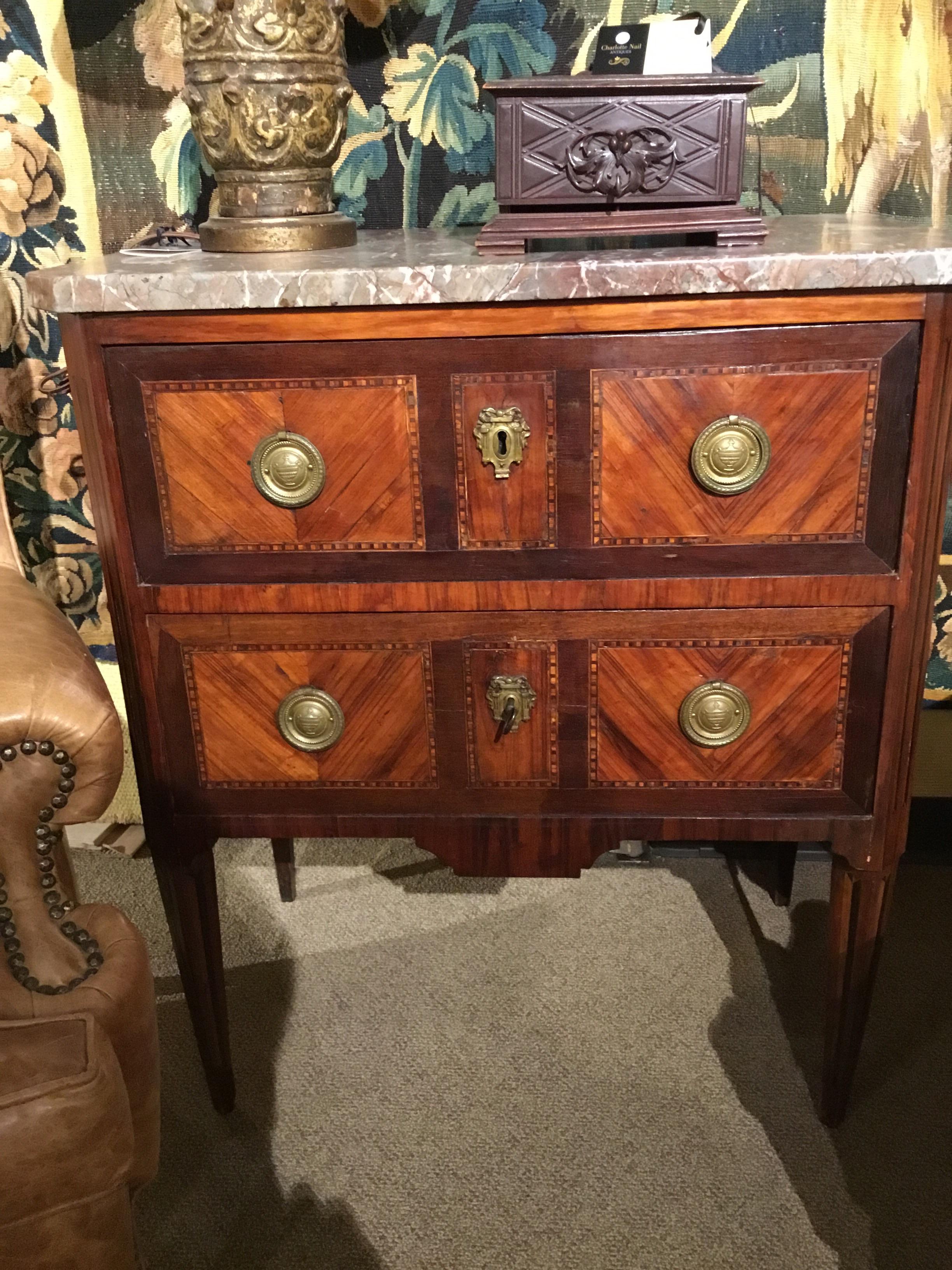 French chest
mahogany and various exotic woods
Marble top in pale gold and pale rouge coloration
Intricate marquetry designs in geometric patterns
