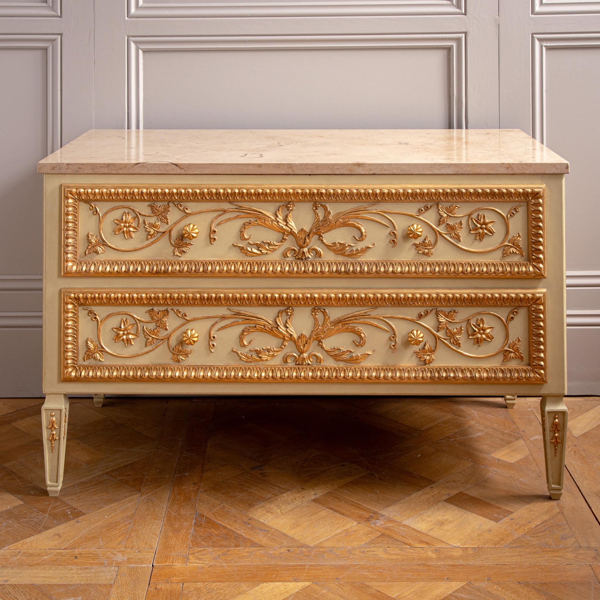A beautifully handcrafted French Louis XVI–style chest of drawers, created by the master artisans at La Maison London. This statement piece features finely hand-carved vine leaves and floral motifs that trail sinuously across the drawer fronts,
