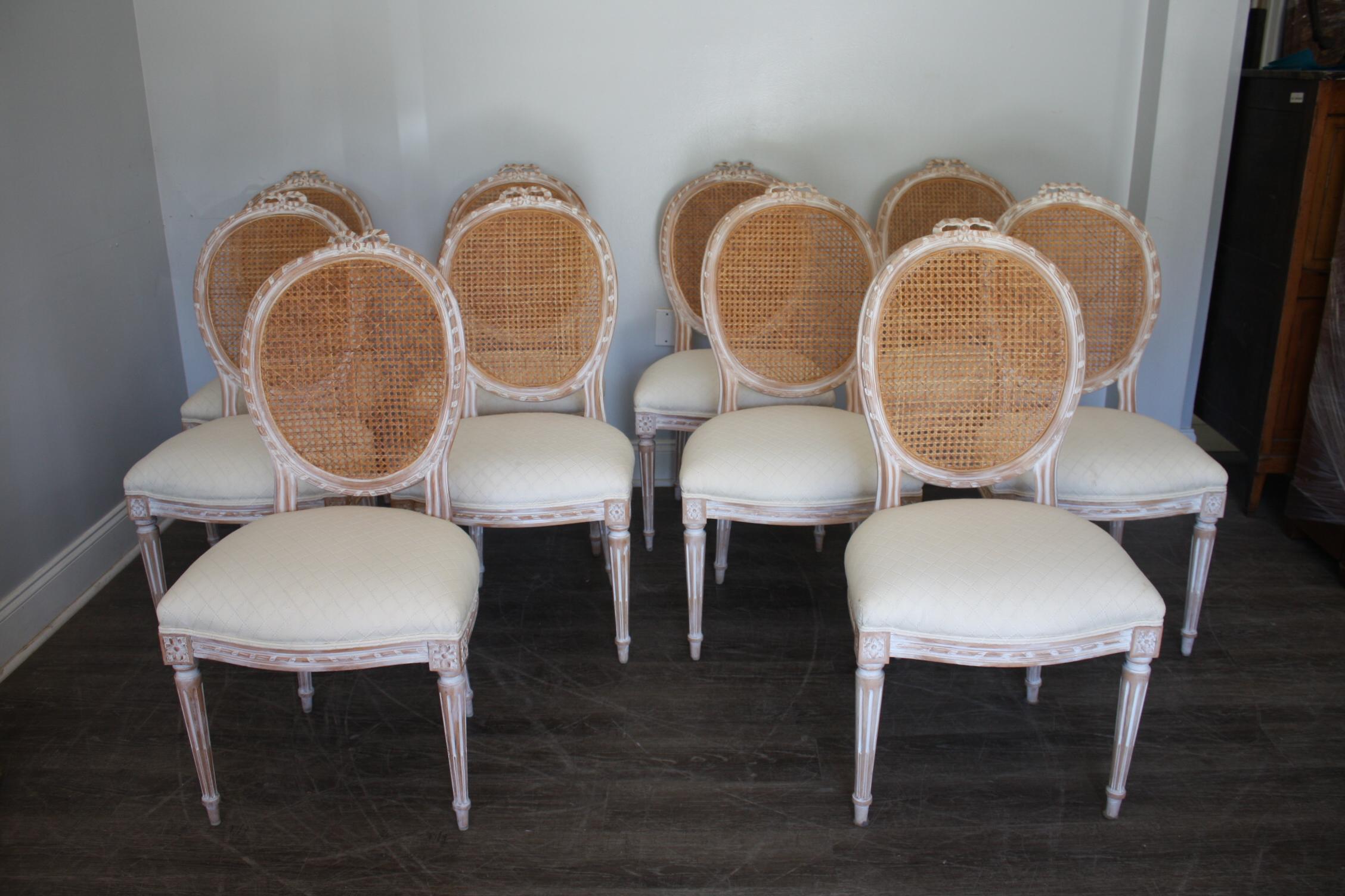 Set of 10 Dining Room Chairs, the back is caned and in good condition as well as the fabric on the seat.