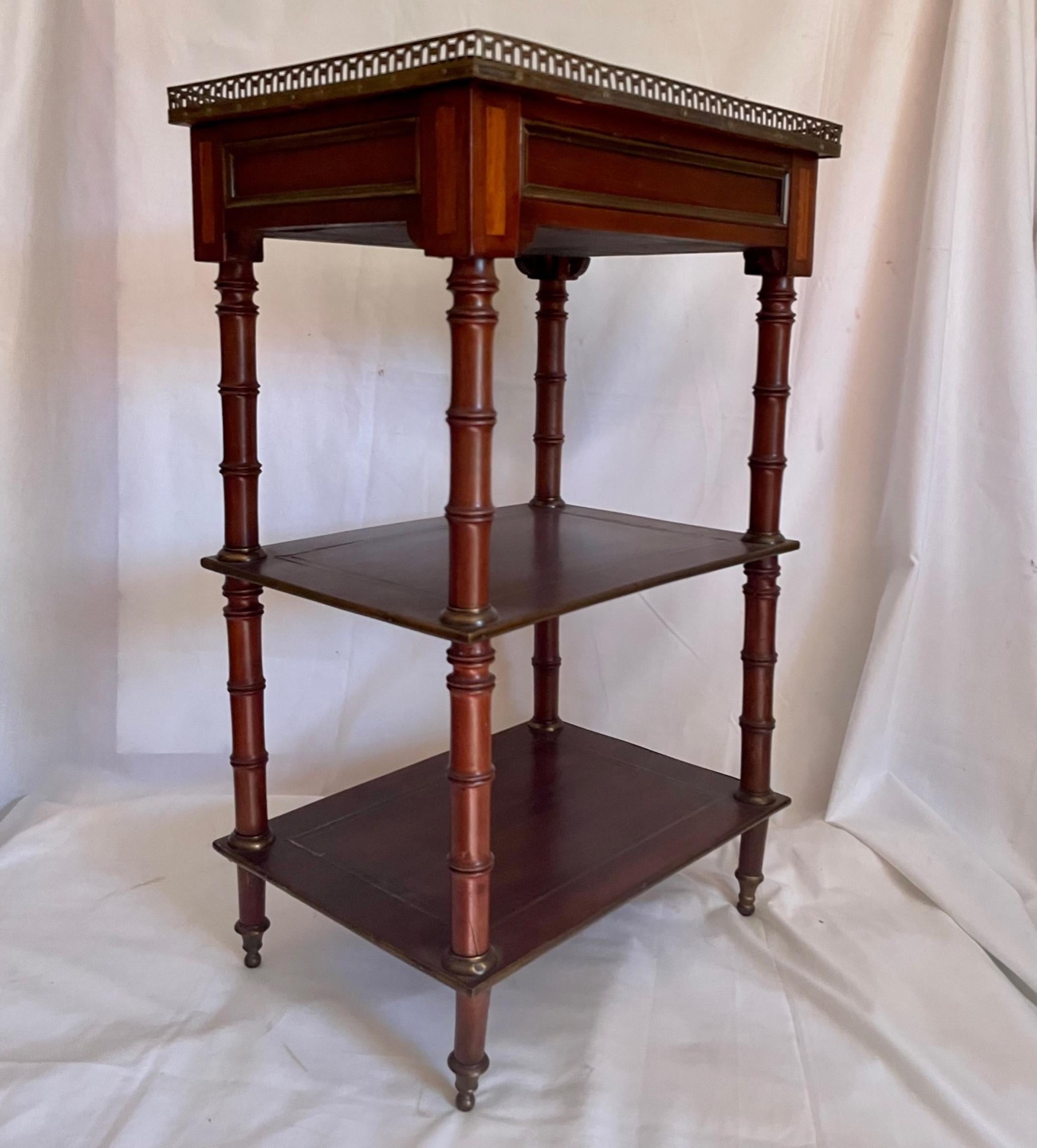 French Louis XVI Directoire Mahogany Etagere Side Table

French Petite and refined highly detailed three-tiered etagere side table with single drawer in mahogany. The top is centered with an elegant amaranth inlay and surrounded by an openwork