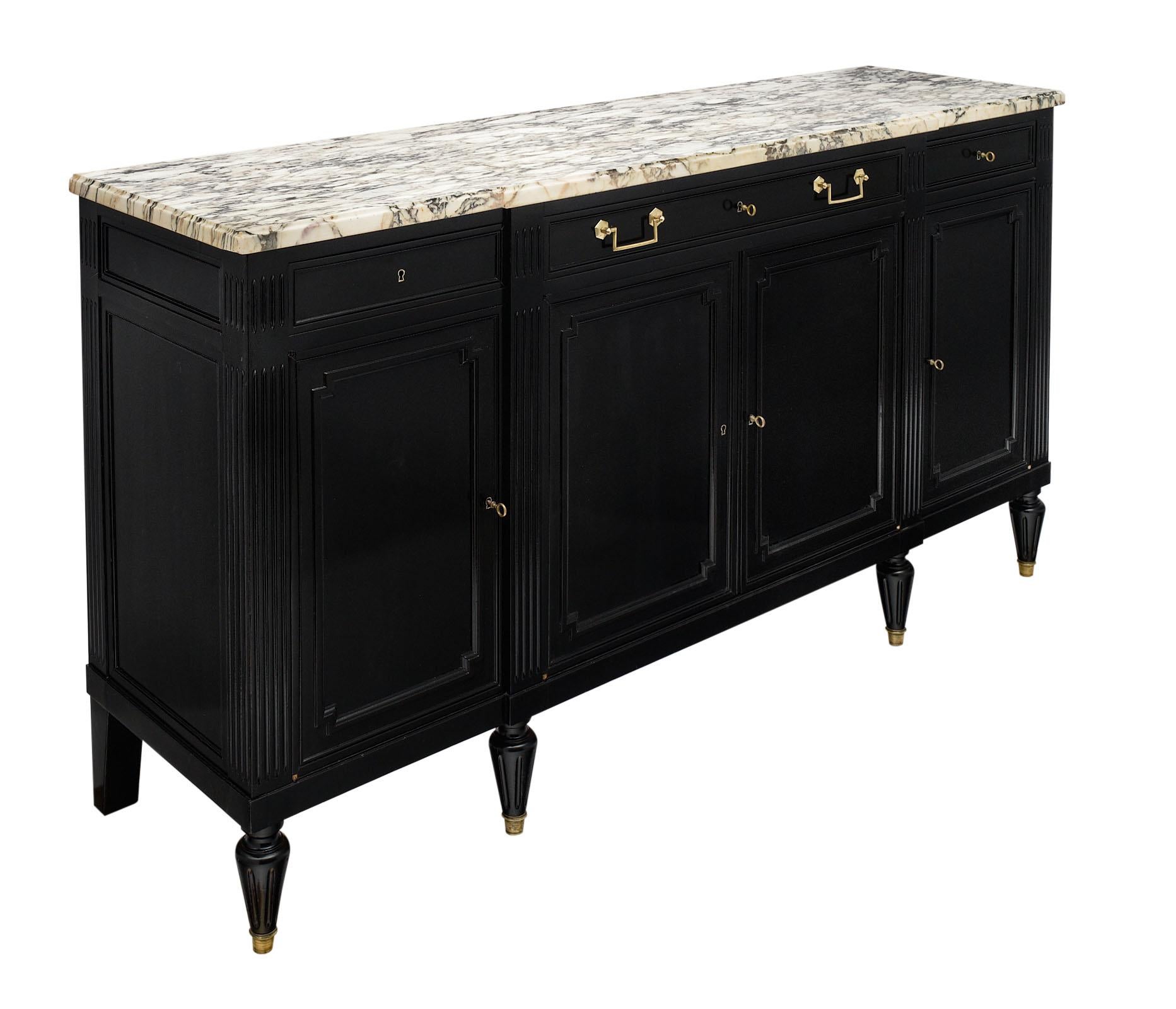 French Louis XVI style ebonized buffet made of solid mahogany and featuring an ebony French polish finish for a lustrous appearance. There are three dovetailed drawers above four doors that open to shelving. The tapered legs add elegance and the