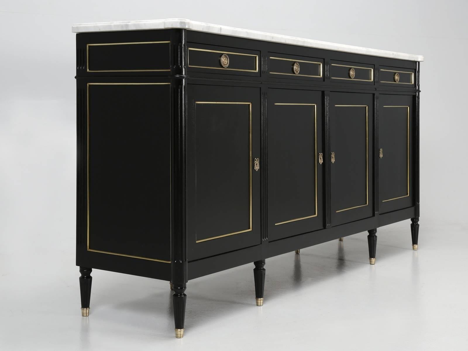 French Louis XVI style buffet that was constructed a little nicer than most, with having solid wood drawer bottoms, while more are thin plywood. The drawers of this Louis XVI style buffet are dove-tailed front and rear, which is another indication