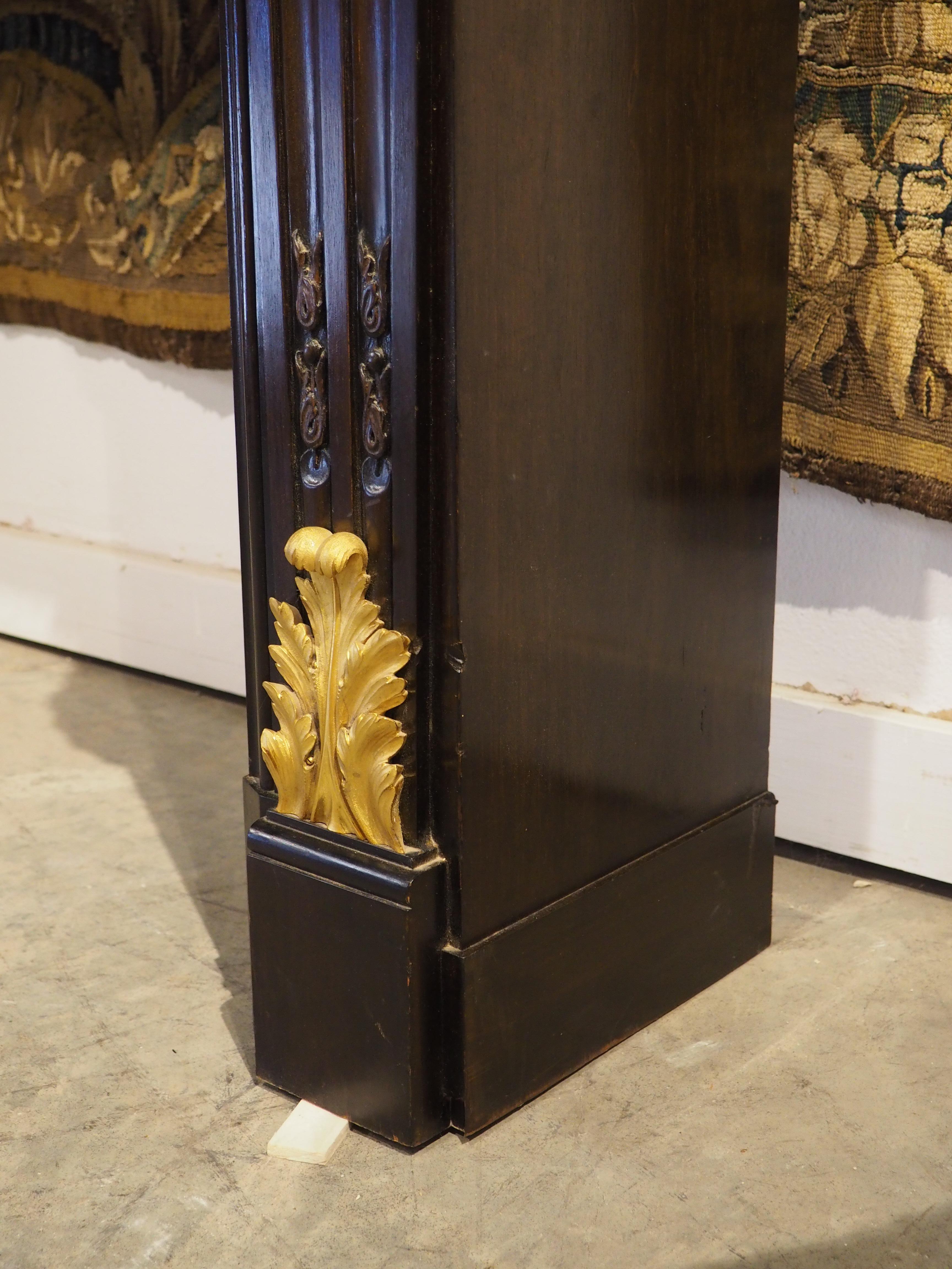 French Louis XVI Style Ebonized Wooden Mantel with Gilt Bronze Mounts, 20th C. In Good Condition For Sale In Dallas, TX