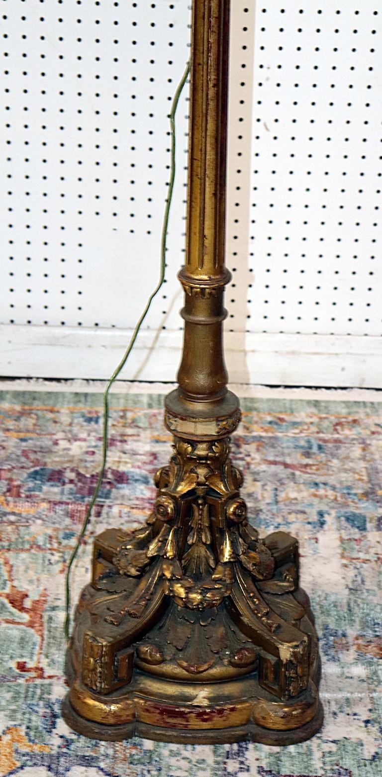 French Louis XV style distressed gilt 3 light floor lamp with a silk shade.