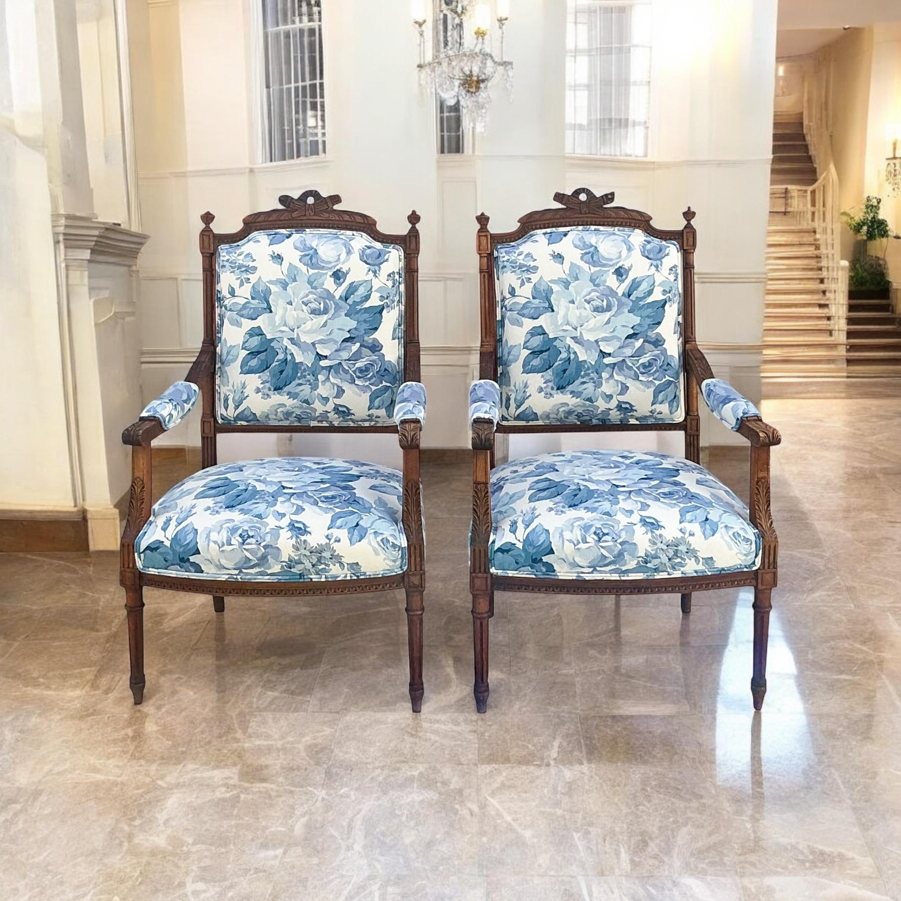 This is a lovely pair of French Louis XVI style carved fruitwood armchairs. The blue and white floral upholstery is new. These have timeless appeal and could work from living room to bedroom.