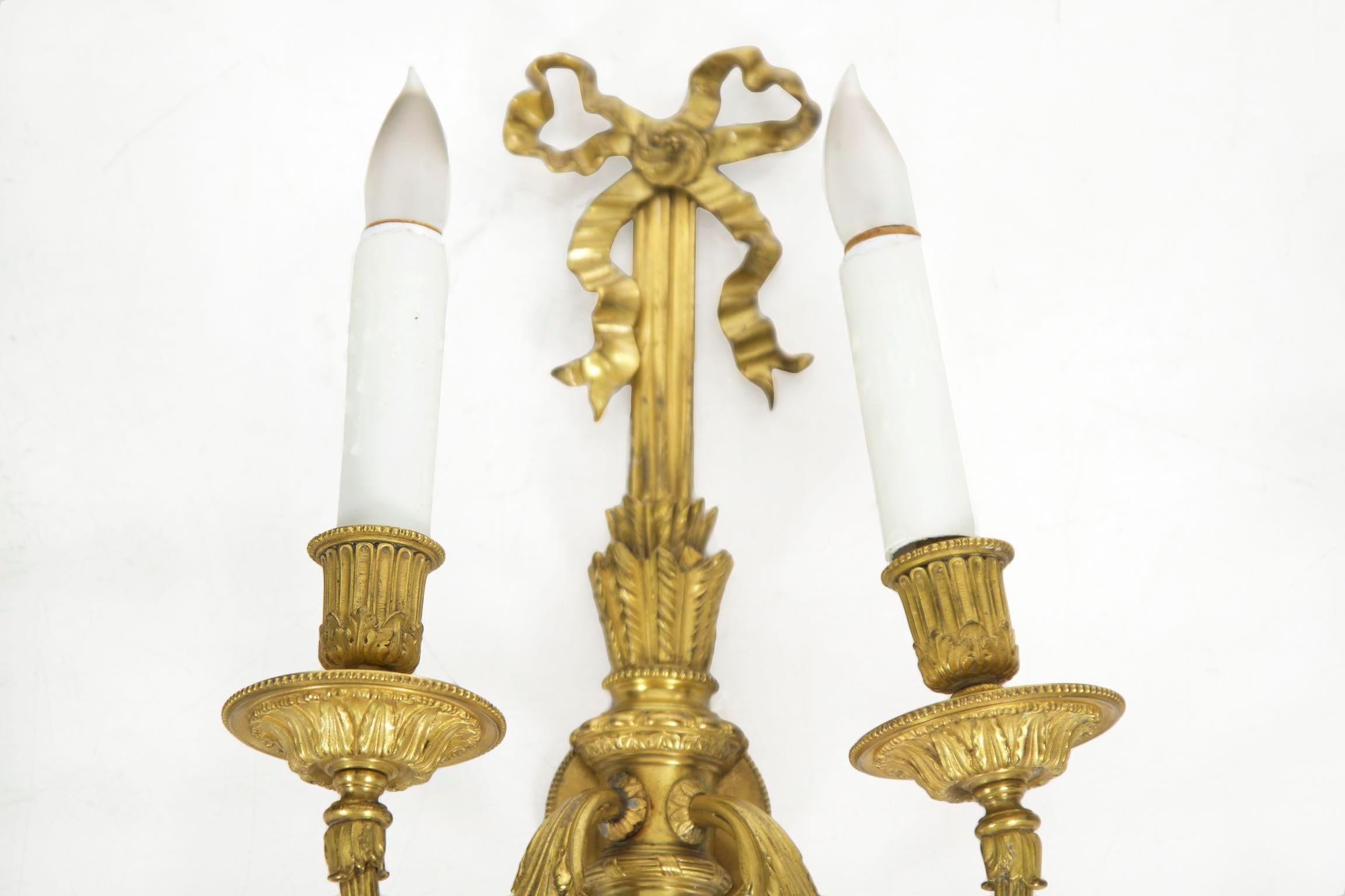 This is an exceptionally well cast gilt bronze wall sconce in the taste of the Louis XVI period, likely crafted during the last quarter of the 19th century. The careful chiseling of all surfaces is noteworthy, each branch projecting from highly