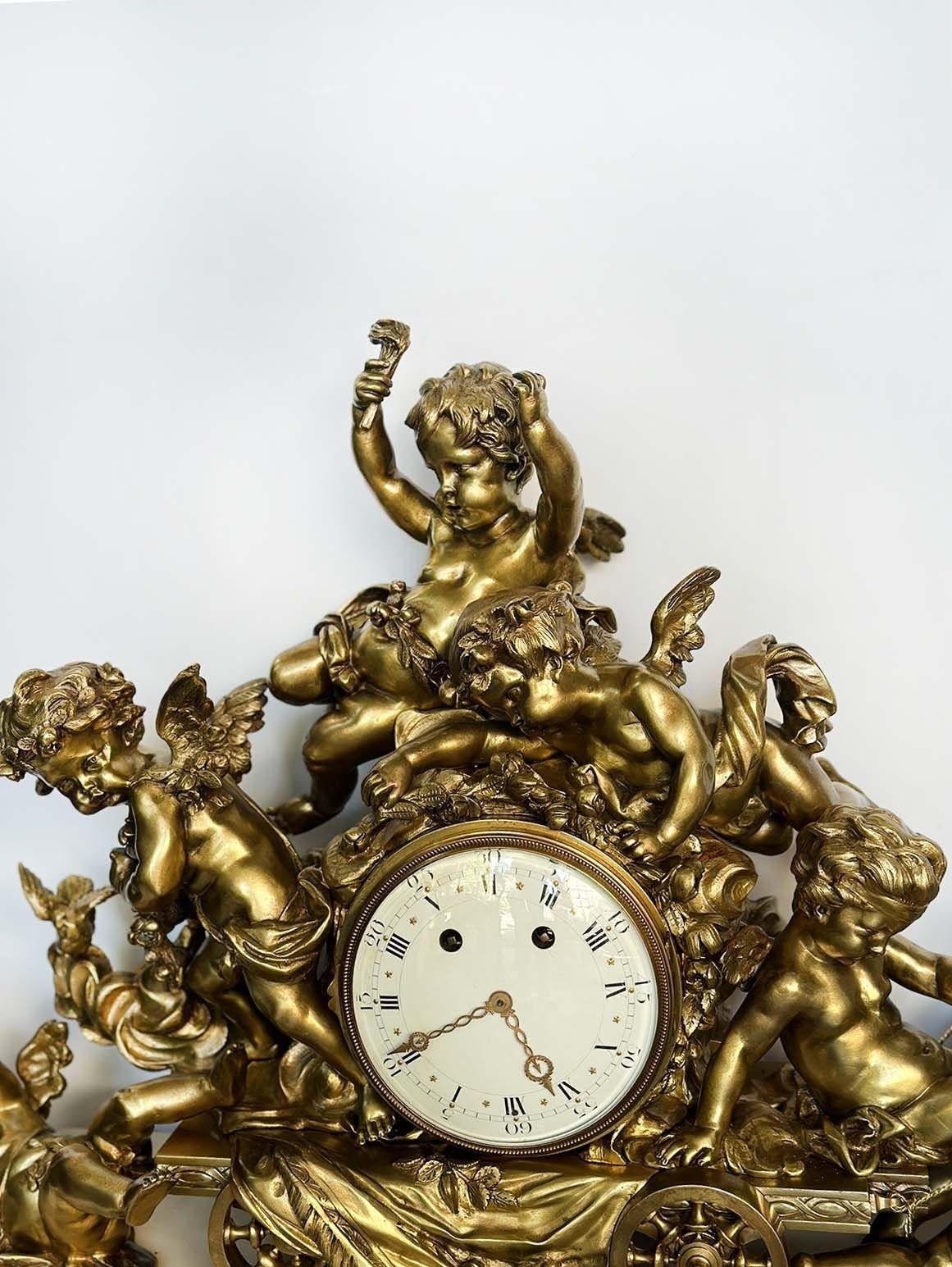 Palatial Louis XVI style mantel clock made of quality gilt bronze and fine marble with great detail all around. Depicts a group of putti figures atop of a celestial cart on a marble plinth supported by bun feet. 
Made in France, c. 1900's. Imported
