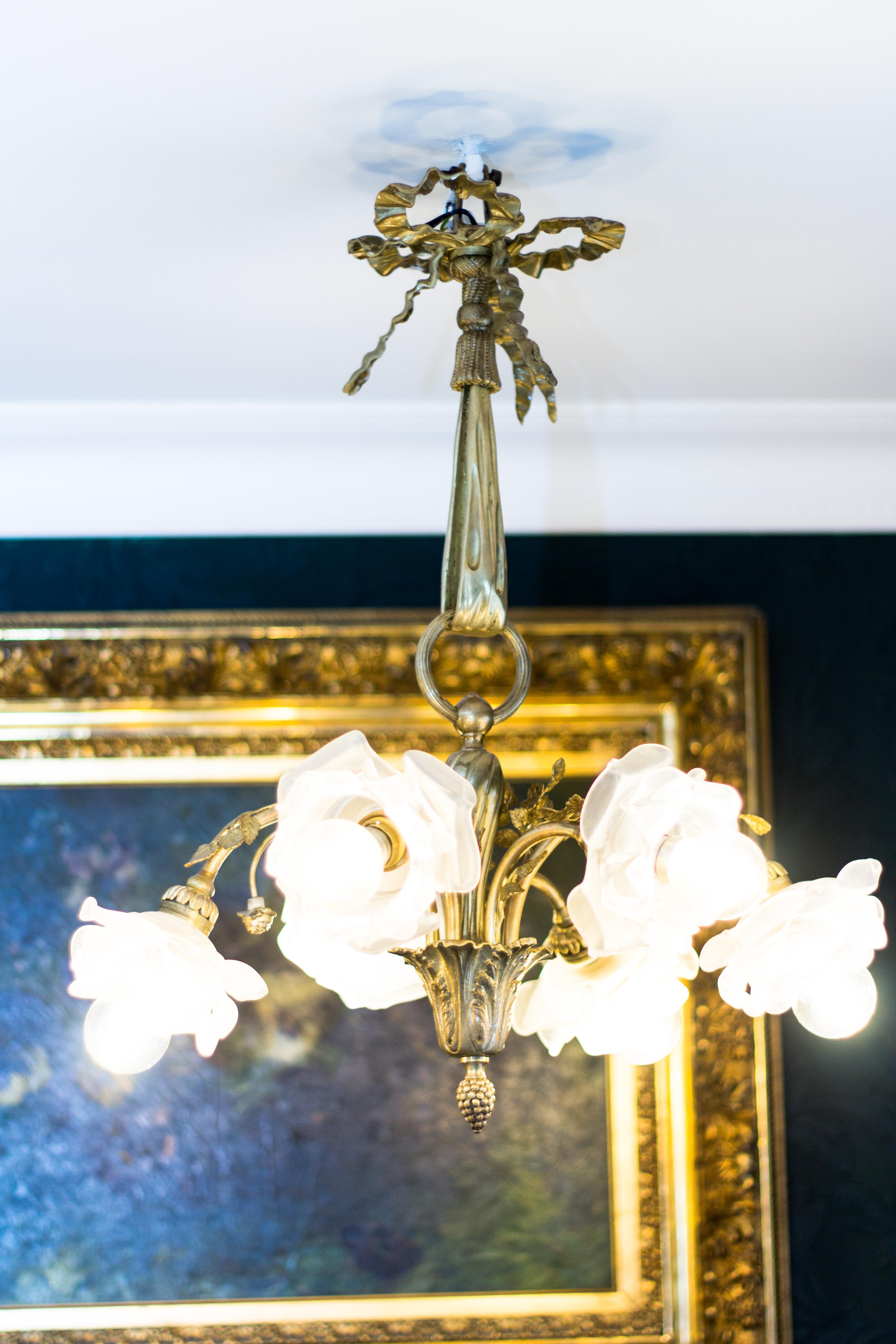 Beautiful Louis XVI style gilt bronze chandelier from the 1920s, six arms with floral shaped frosted glass shades, decorated with cast bronze roses. Six-light chandelier with six B22 sockets, new wiring.
Measures: Height is 20.5 inches / 52 cm,