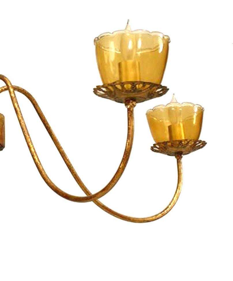 French Louis XVI-Style (Mid-20th Century) gilt metal 5 scroll arm chandelier with amber glass bobeche and supported by a gilt wood center post with finial bottom.
