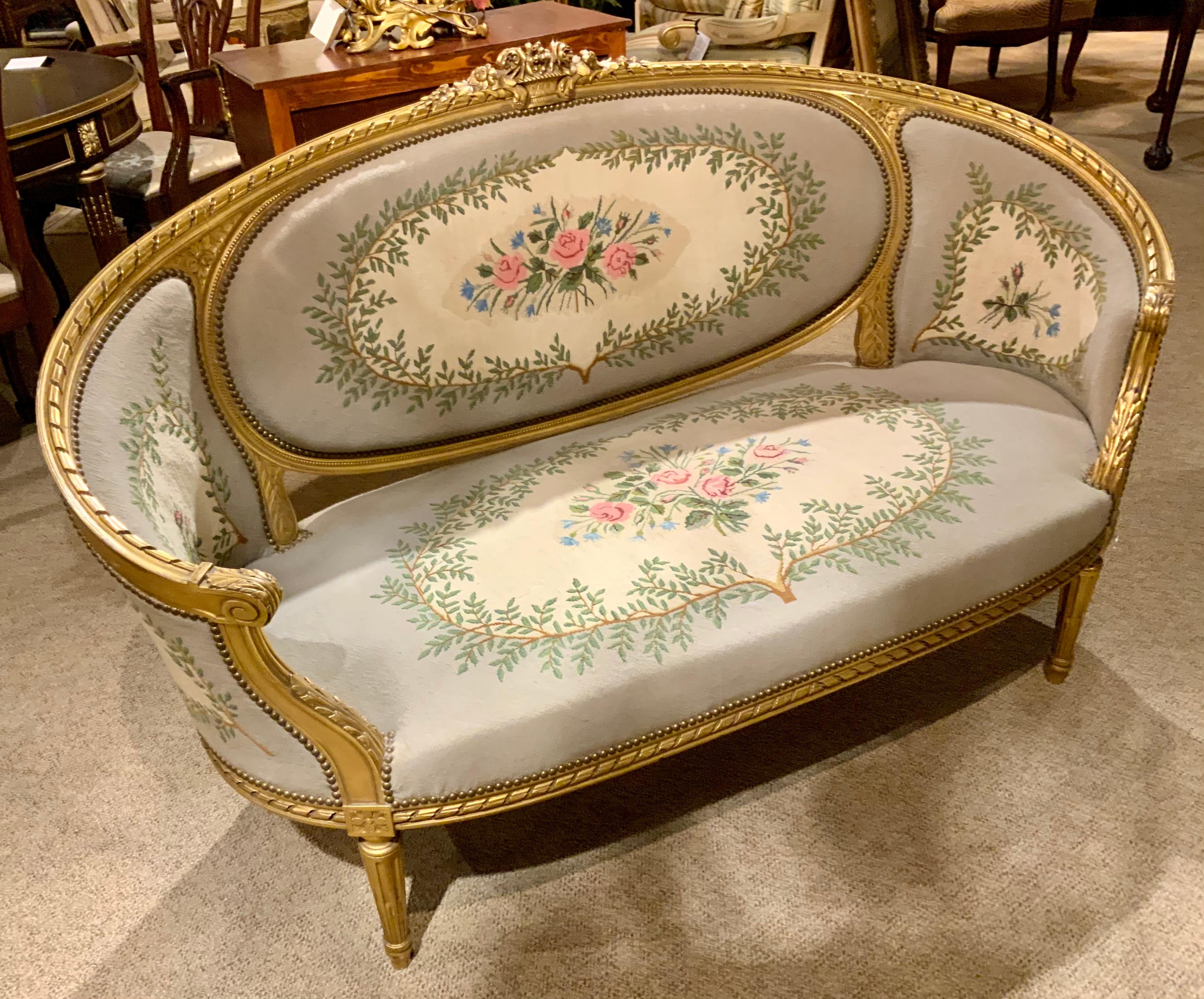The fine carving and the graceful shape make this canapé especially 
Appealing. The gilding is original and in fine original condition. The
Needle point Upholstrey is in exceptional condition without stains or
Wear. It is comfortable and stable