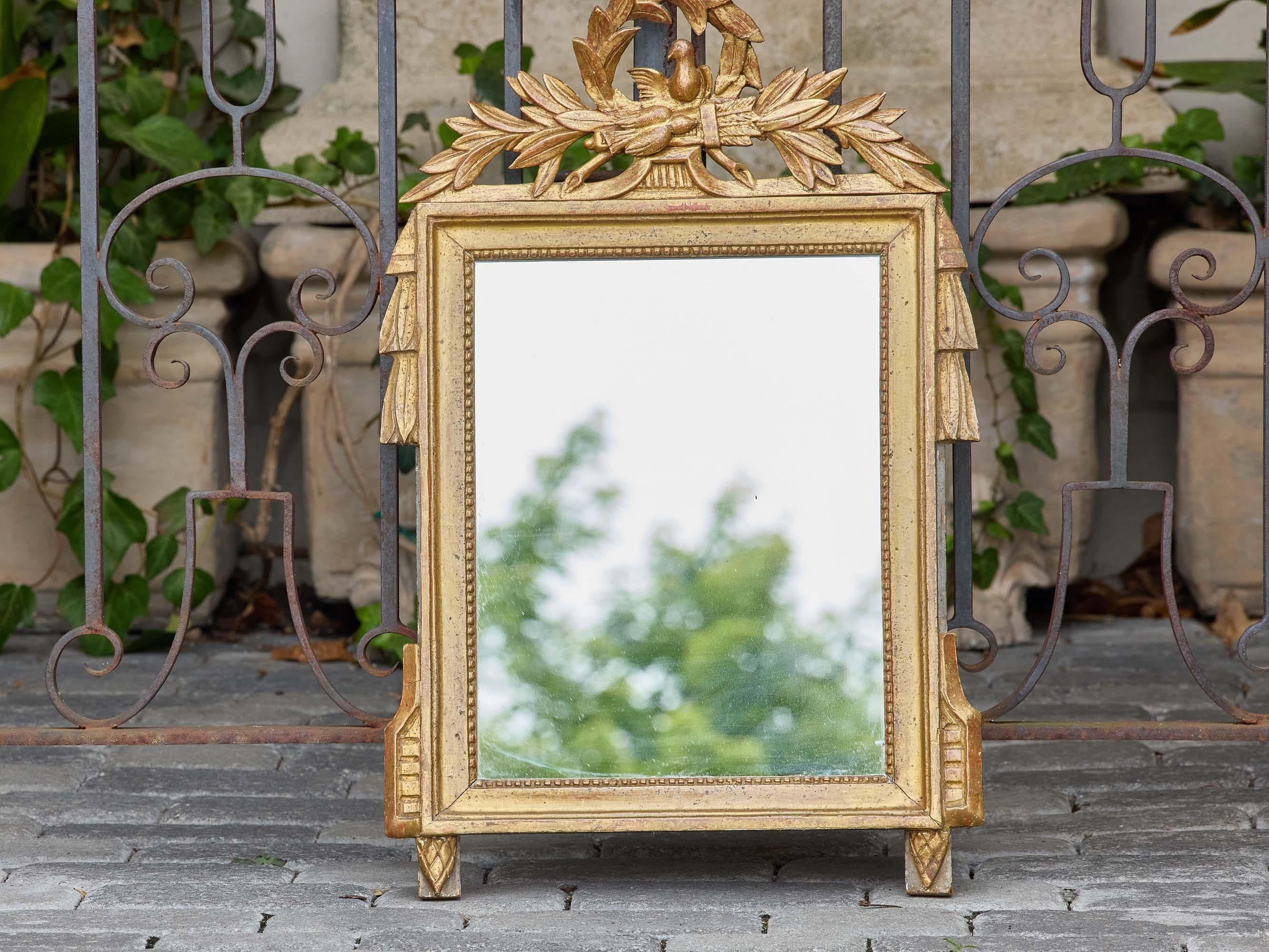 Carved French Louis XVI Style Giltwood Mirror with Dove and Laurel Crest, circa 1920 For Sale