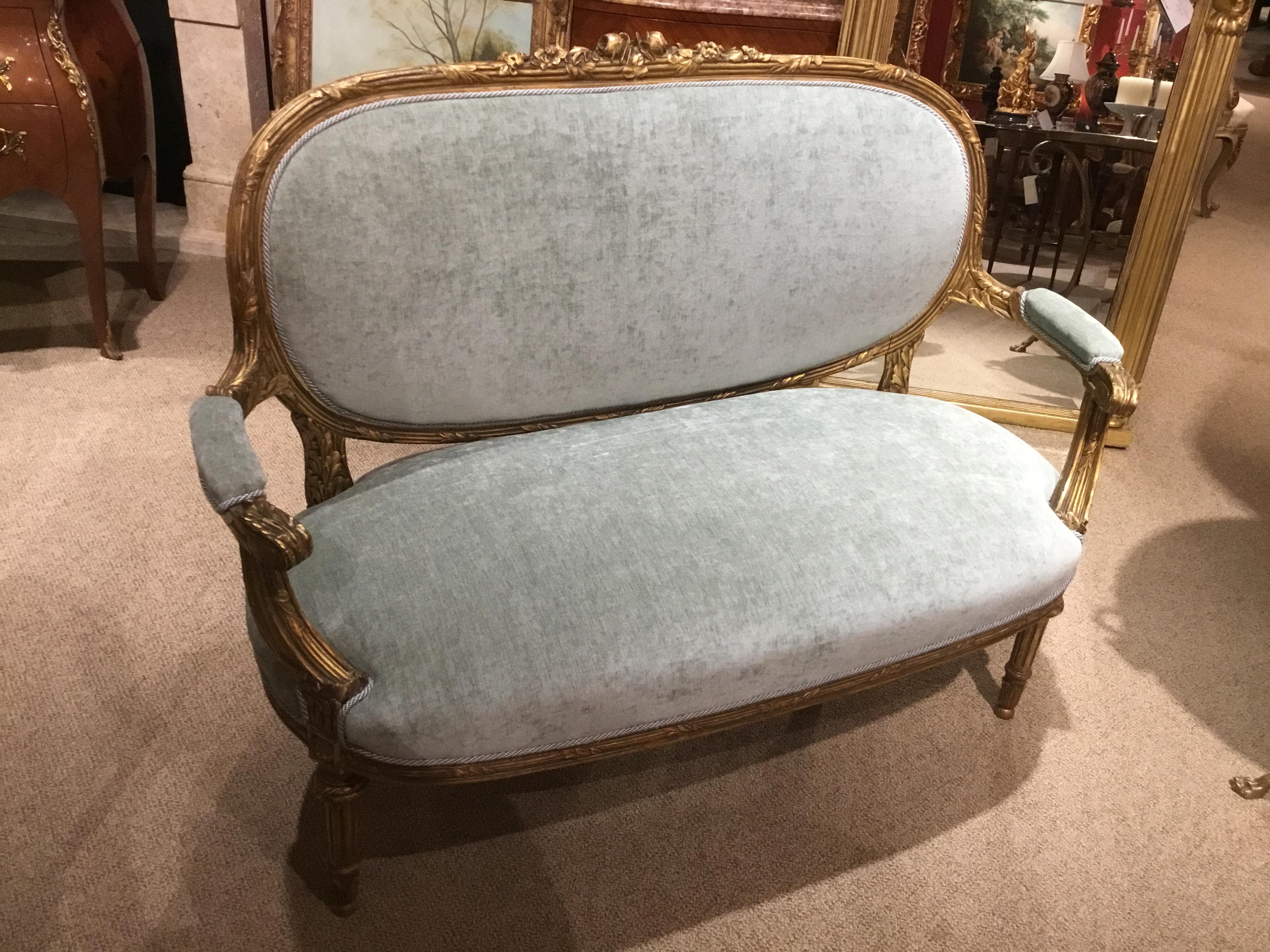 French love seat in a sea foam teal hue new upholstery. The back upholstered
In a small check of teal and white. Corded with a matching trim.
The back is gracefully curved. The center crest is carved in a rose motif.
Frame is study and tight.