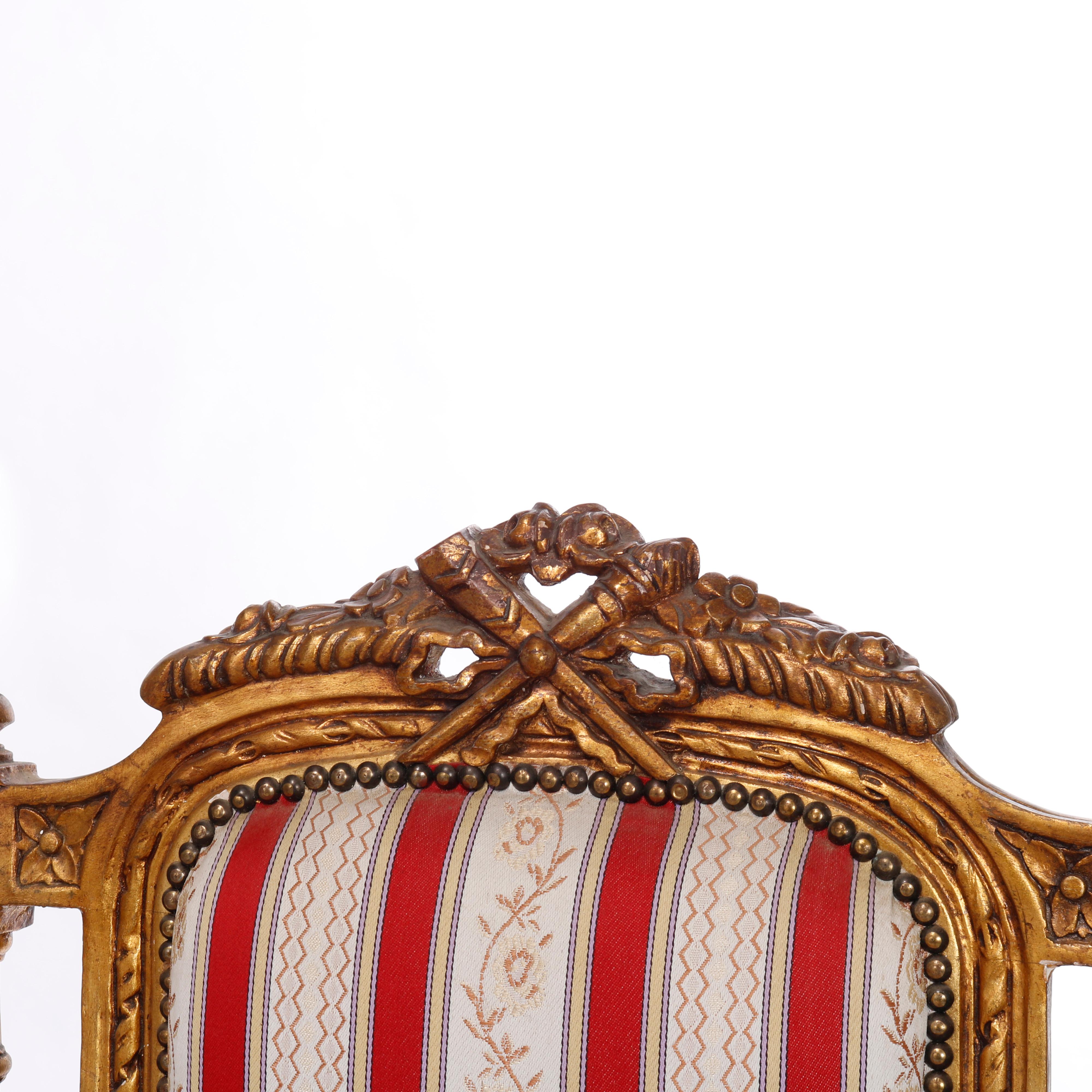 A pair of French Louis XVI style armchairs offer giltwood frames with upholstered seats and backs, carved foliate crest, scroll form arms, acanthus elements and raised on turned and tapered legs, 20th century

Measures - overall 43.75''h x 27.25''w