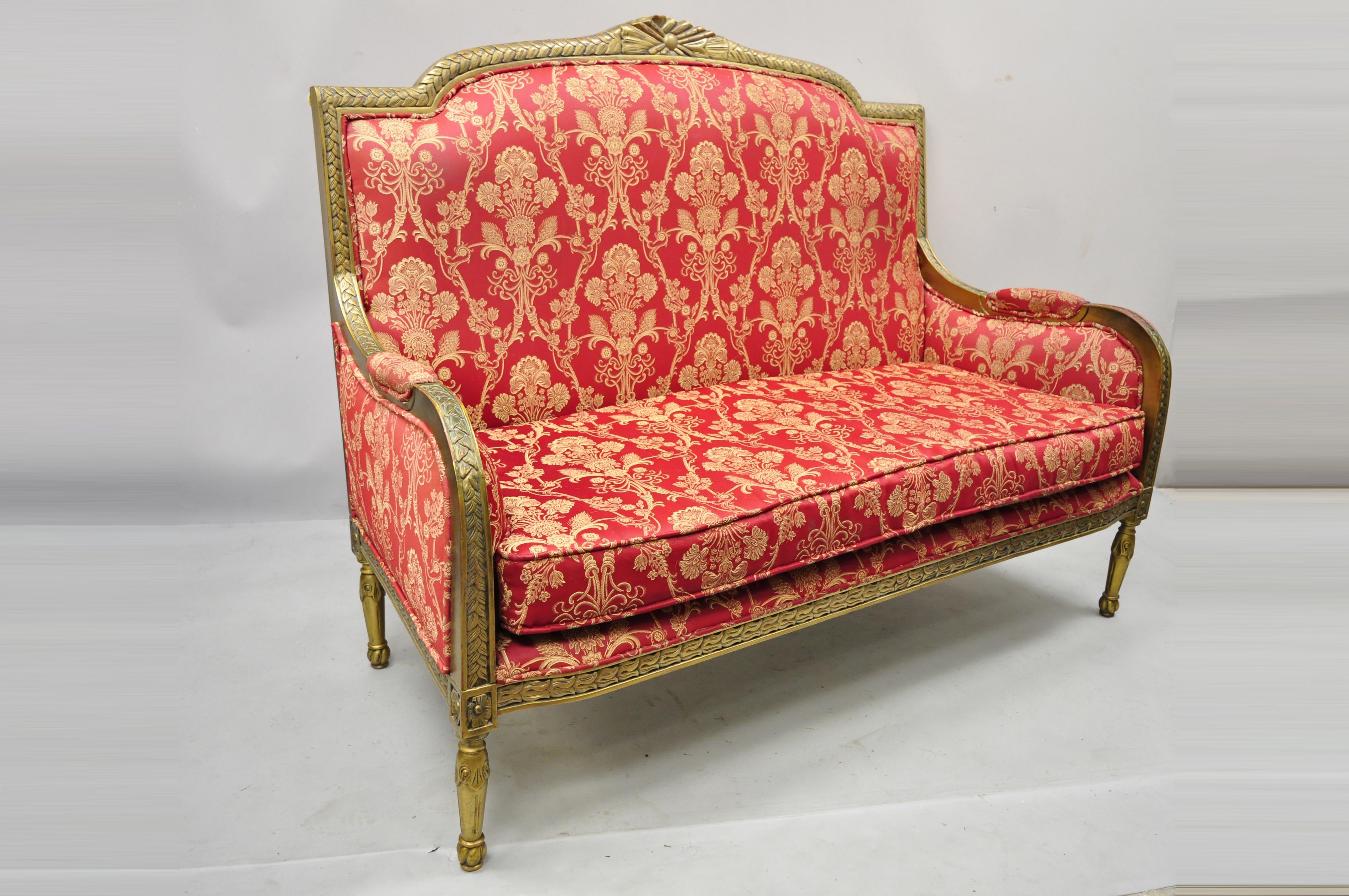 French Louis XVI style gold painted red upholstered settee sofa loveseat decorator chair. Item features solid wood frame, upholstered arm rests, gold distress painted finish, nicely carved details, tapered legs, great style and form. Circa late 20th