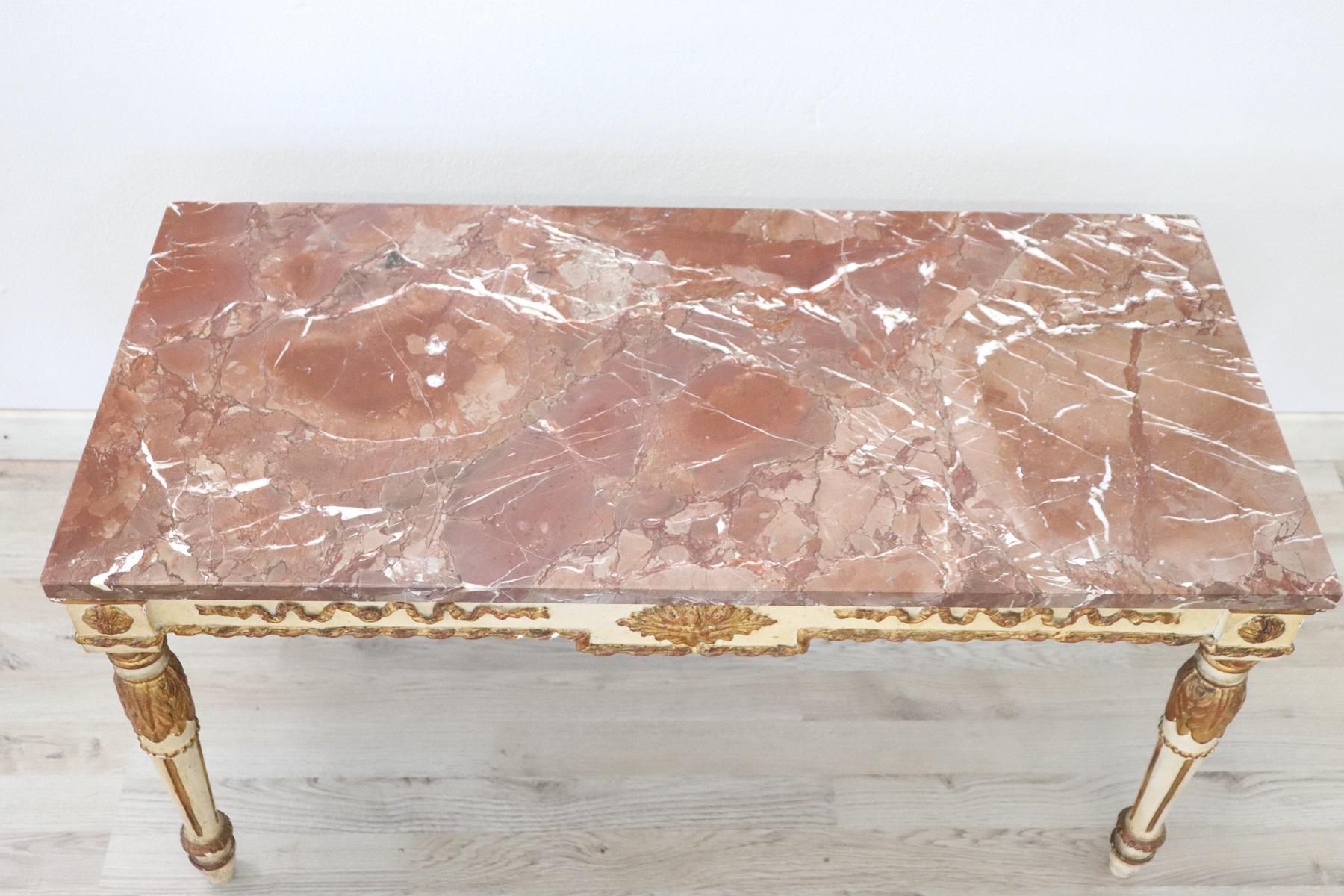 French rectangular coffee table from 20th century. Table in carved, gilded and lacquered wood in Louis XVI style. Marble top in good condition. Coffee table perfect in living room.