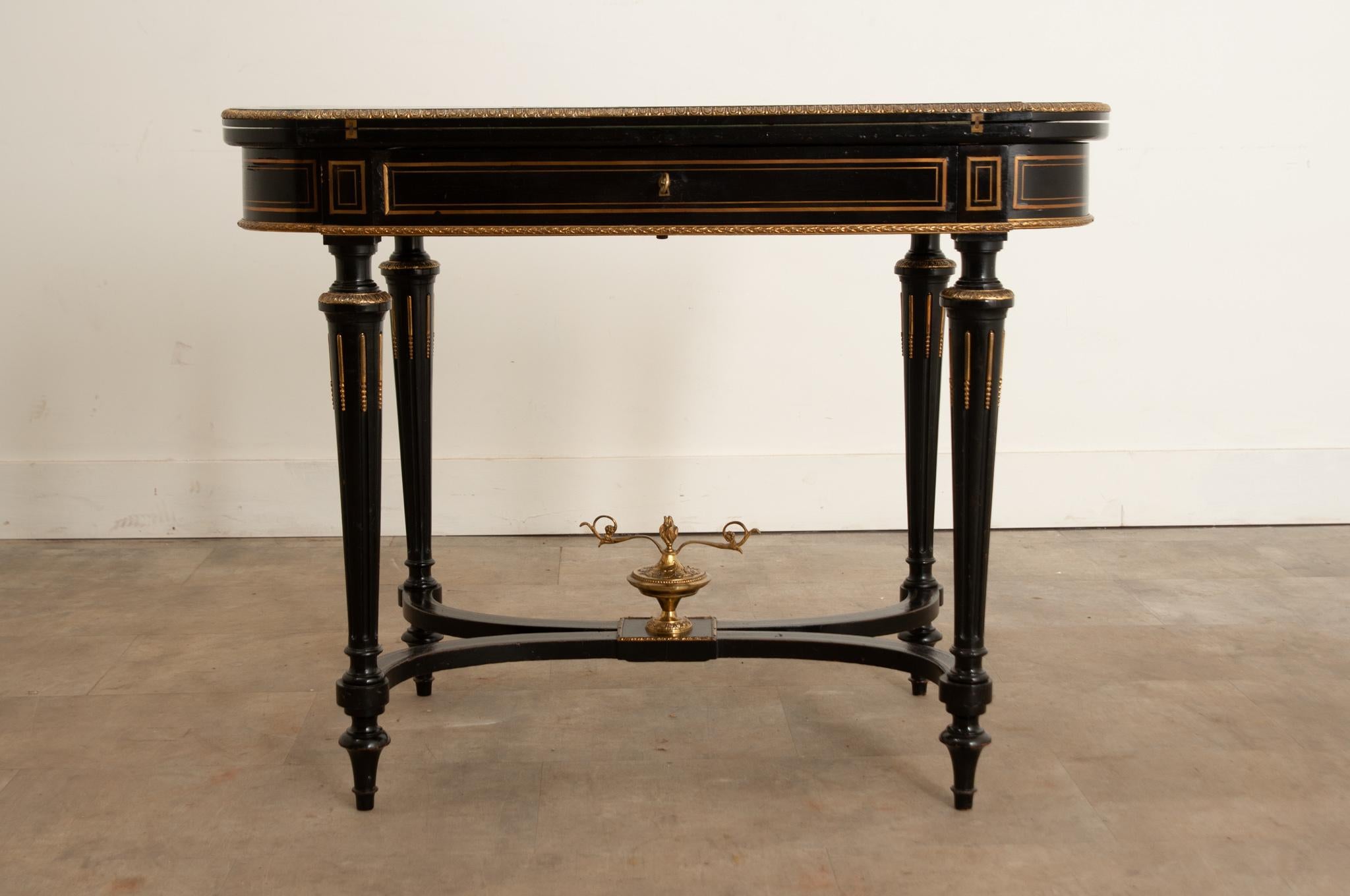 An elegant and refined Louis XVI style game table from 19th Century France. This outstanding antique table can serve multiple roles. It could be used as a console, center or occasional table, but one of the many things that makes this table special