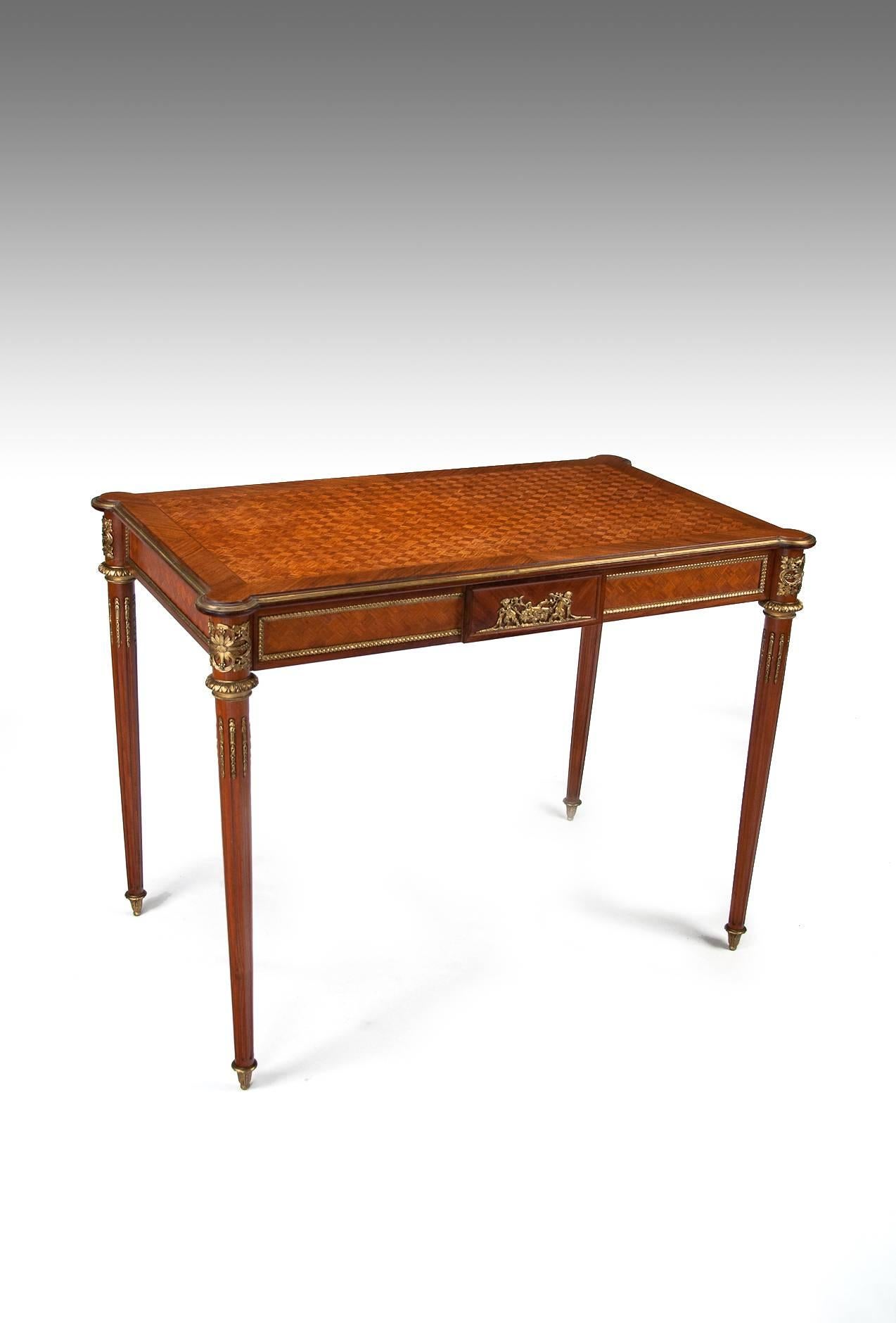 A very fine French late 19th- early20th-century Louis XVI style kingwood parquetry and ormolu-mounted ladies writing table.  Circa 1890-1900.

The cubed parquetry inlaid rectangular top with outset circular corners having an inlaid and crossbanded