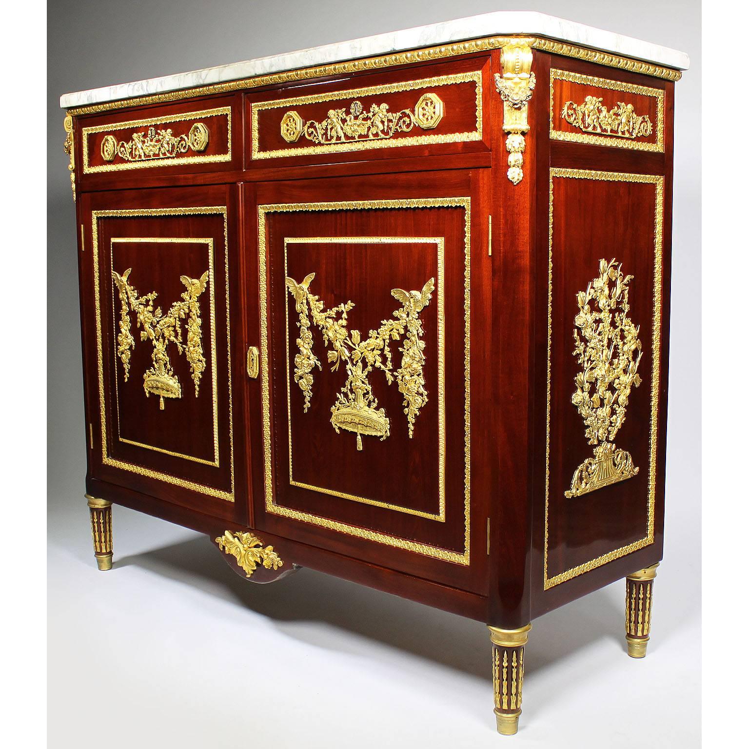 A fine French Louis XVI style mahogany and gilt-bronze mounted two-door and two-drawer server commode with a brêche violette marble top, attributed to François Linke (1855-1946). The twin front doors, concealing a single shelf interior, each