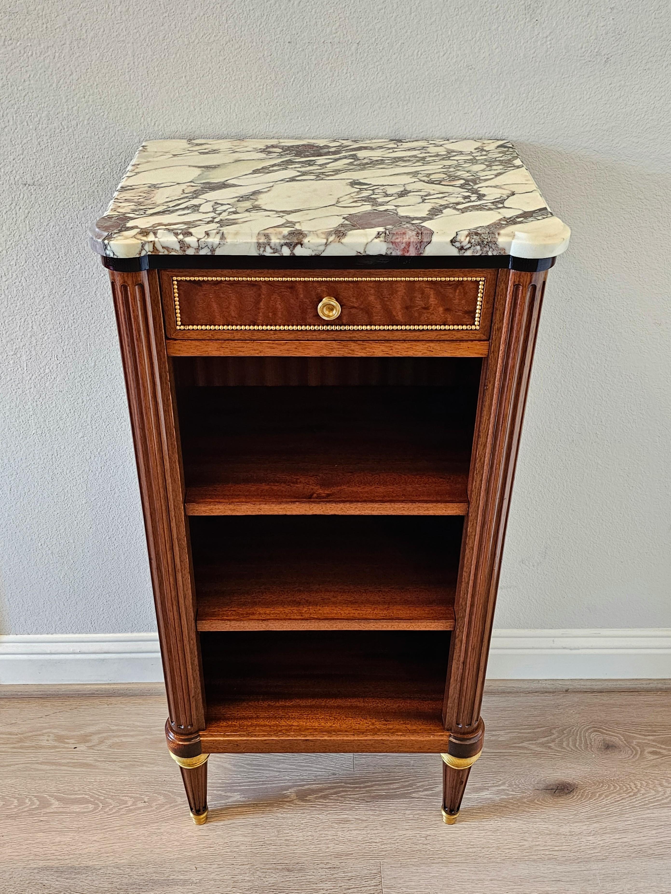 A stunning fine quality vintage French Louis XVI signed gilt brass exotic mahogany calacatta marble open shelf side cabinet bibliothèque. circa 1960

Exquisitely hand-crafted in France in the mid-20th century, almost certainly Paris, exceptionally