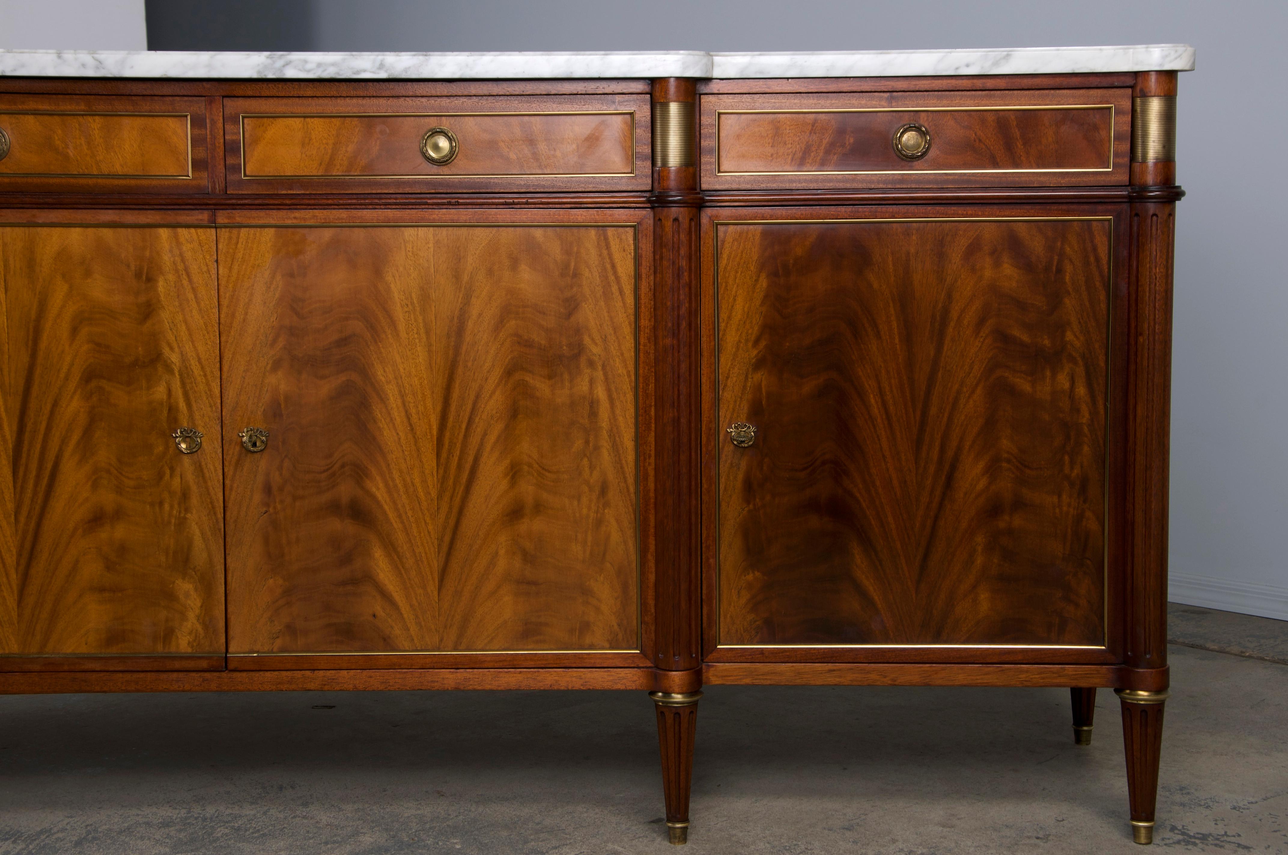 An exquisite early 20th-century French sideboard or buffet in the Louis XVI style, sourced from Provence, France. Masterfully hand-crafted from mahogany, this elegant piece features a long, narrow 7'7