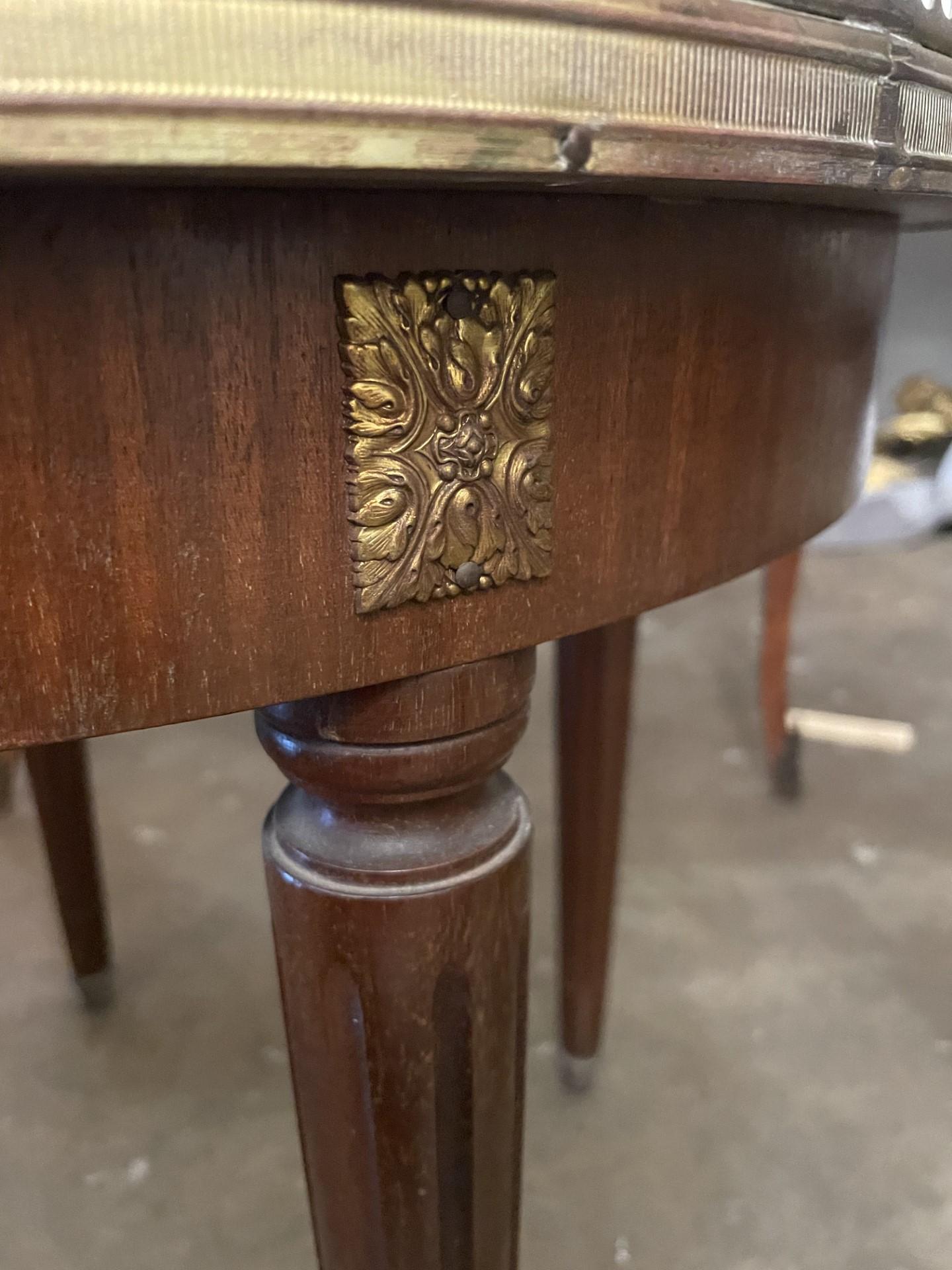 French Louis XVI Style Marble Top Mahogany Bouillotte Table
having pierced metal gallery and inset marble top, over one fitted drawer, rising on tapered legs ending in brass sabots.